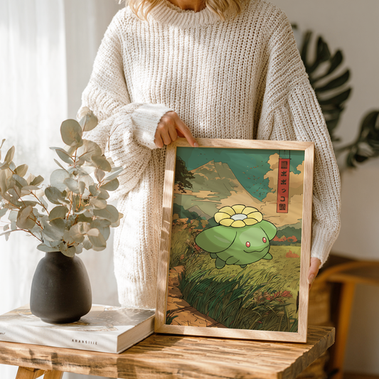 Person holding a framed artwork of Skiploom Pokemon, standing in a room with plants and decor.