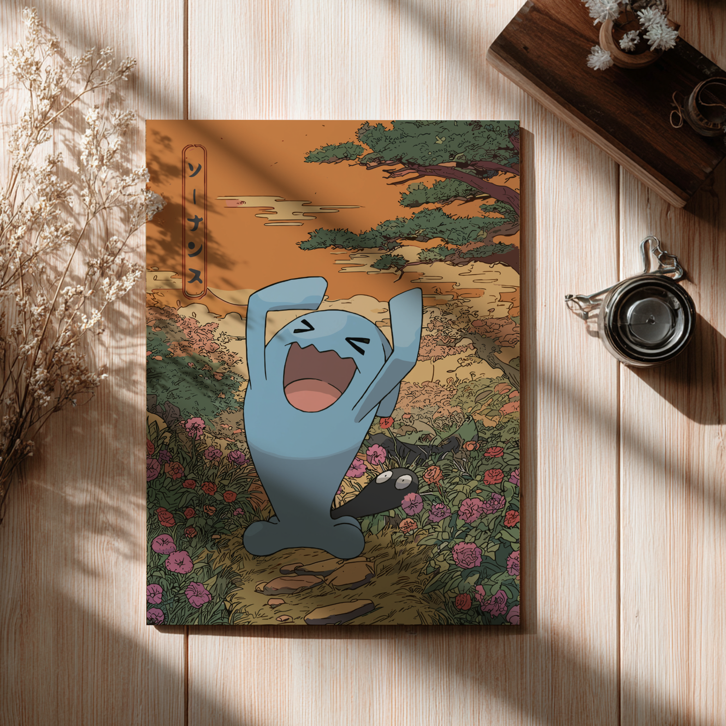 Notebook with Wobbuffet Pokemon on a nature-themed cover, placed on a wooden surface.