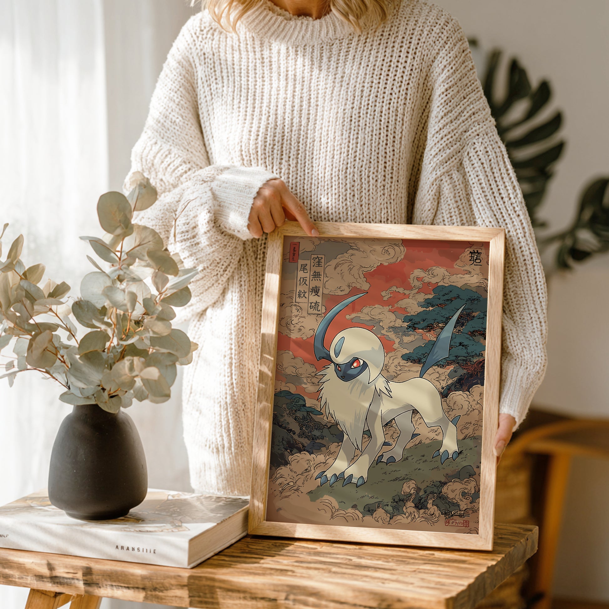 Person holding a framed artwork of Absol Pokemon in a natural setting