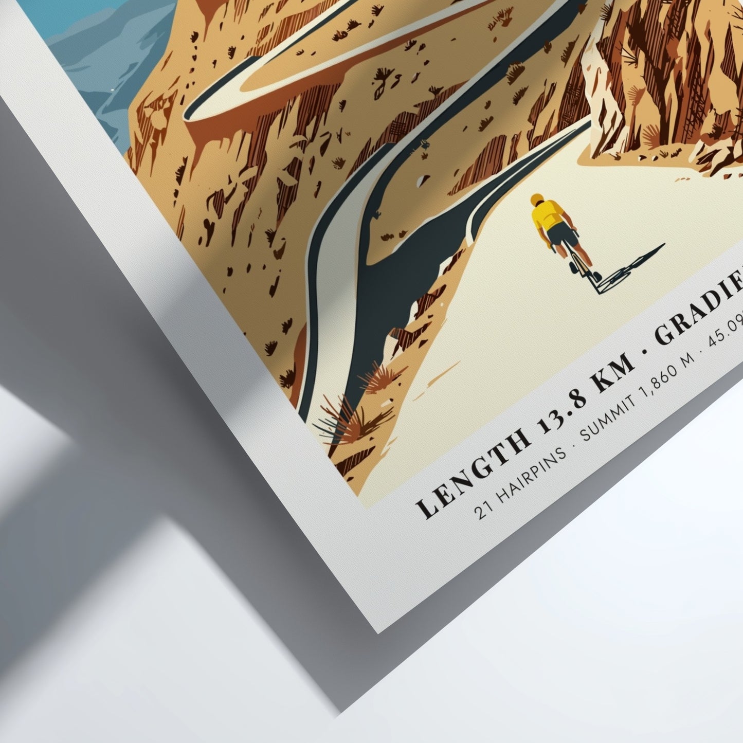 Poster featuring a lone cyclist climbing the winding Alpe D'Huez road in France.