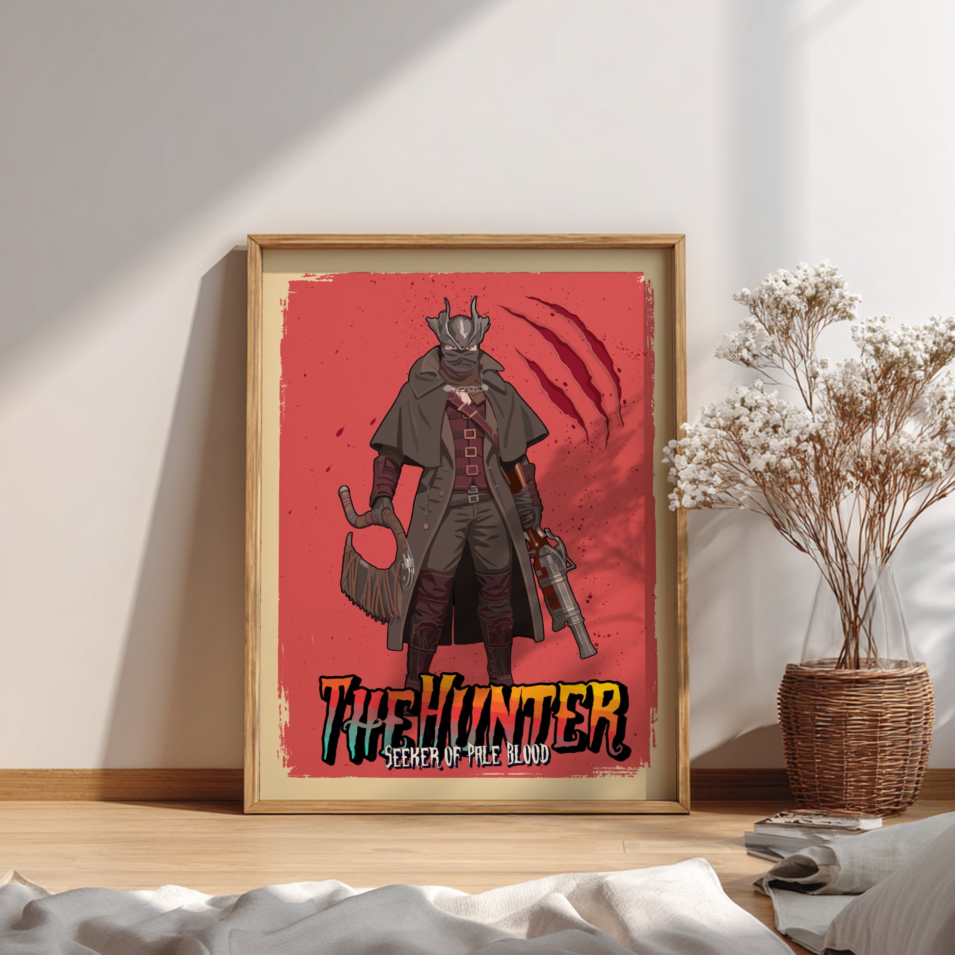 Framed poster of The Hunter from Bloodborne, placed on a wooden surface with a plant in the background.