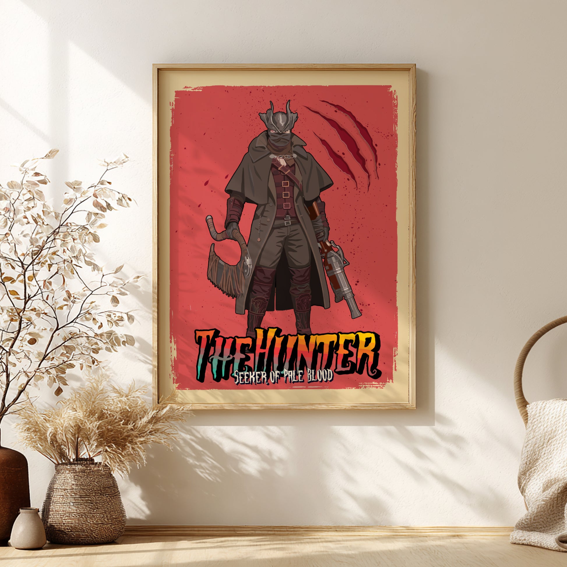 Framed poster of The Hunter from Bloodborne on a red background, placed in a room with decor elements.