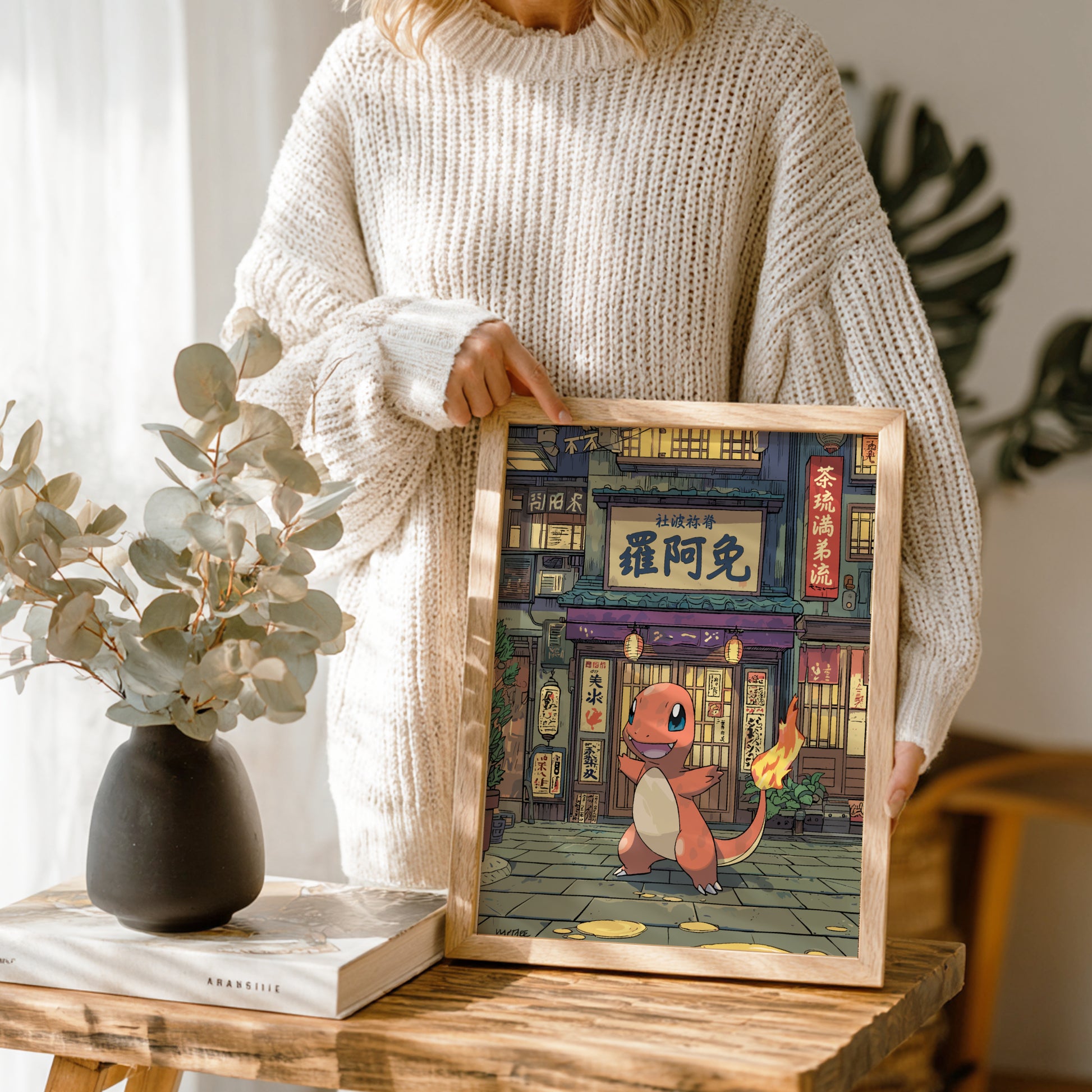 Person holding a framed illustration of Charmander Pokemon character in a store setting