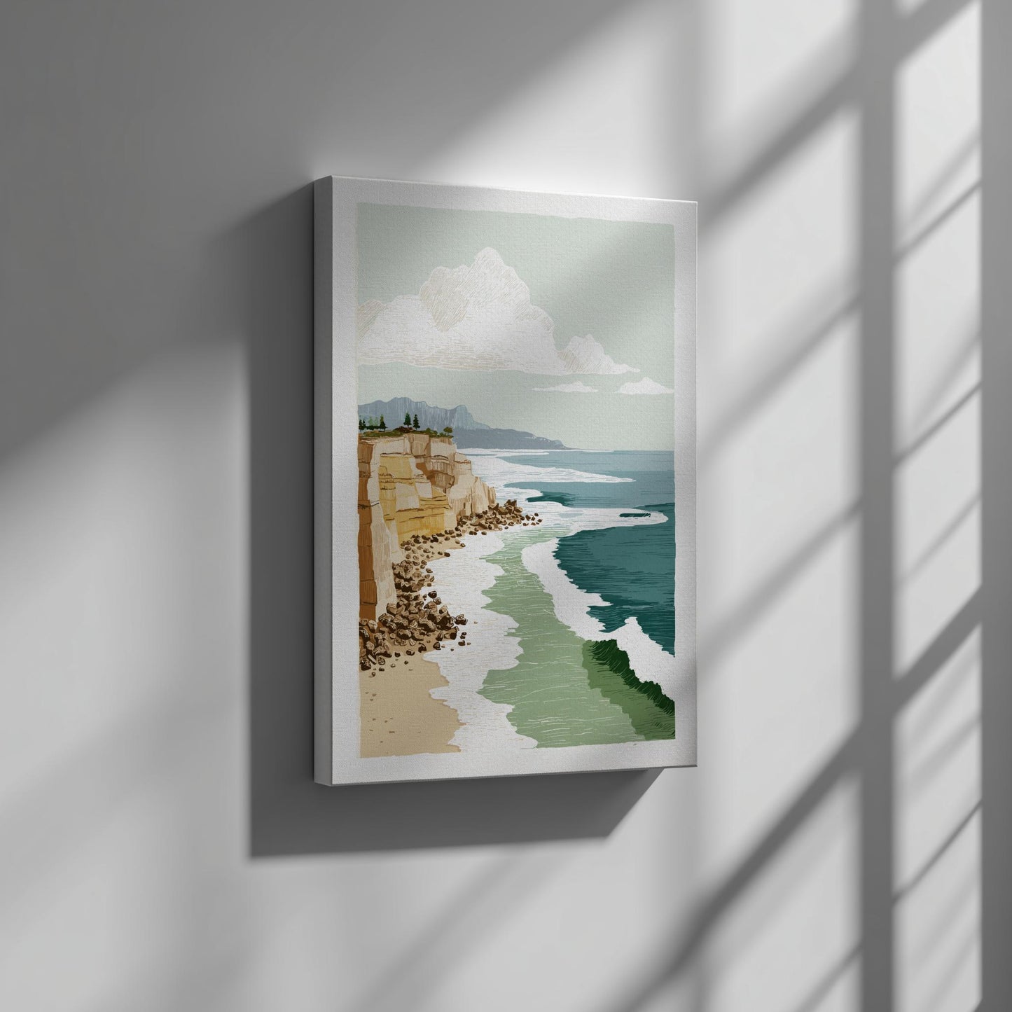 Framed artwork of a coastal scene with cliffs and ocean on a wall.