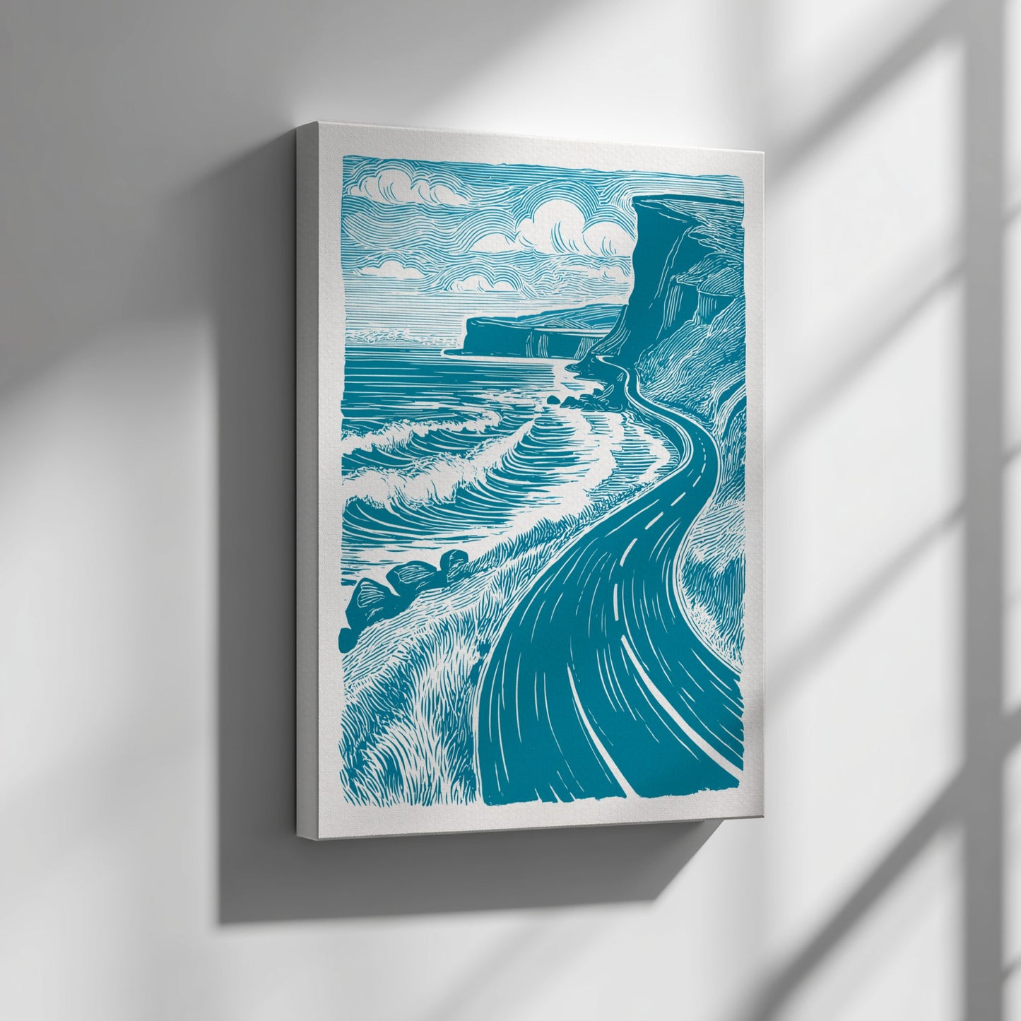 Framed artwork of a coastal scene with waves and cliffs on a white wall.