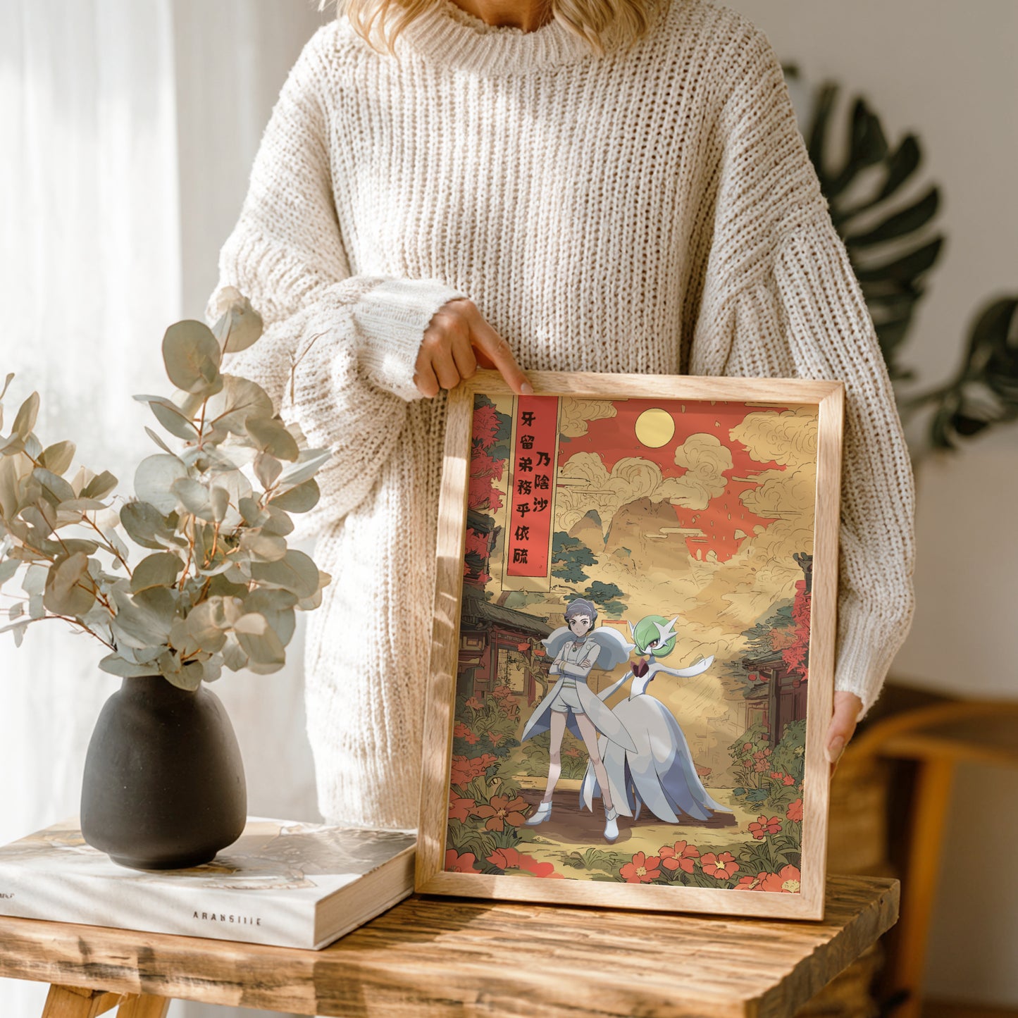 Person holding a framed artwork with a decorative background