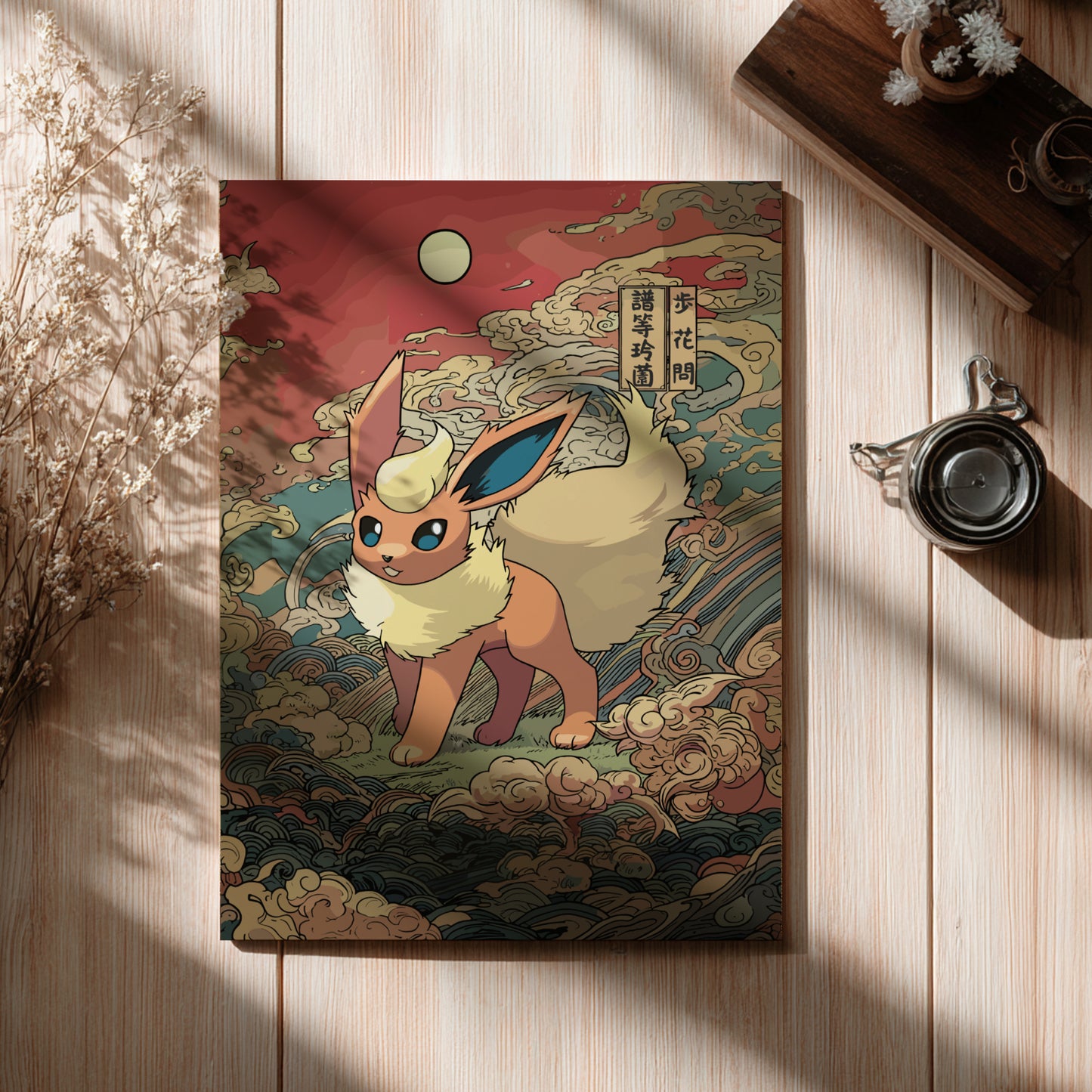 Flareon Pokemon character on a decorative notebook with a wooden surface and plant accents
