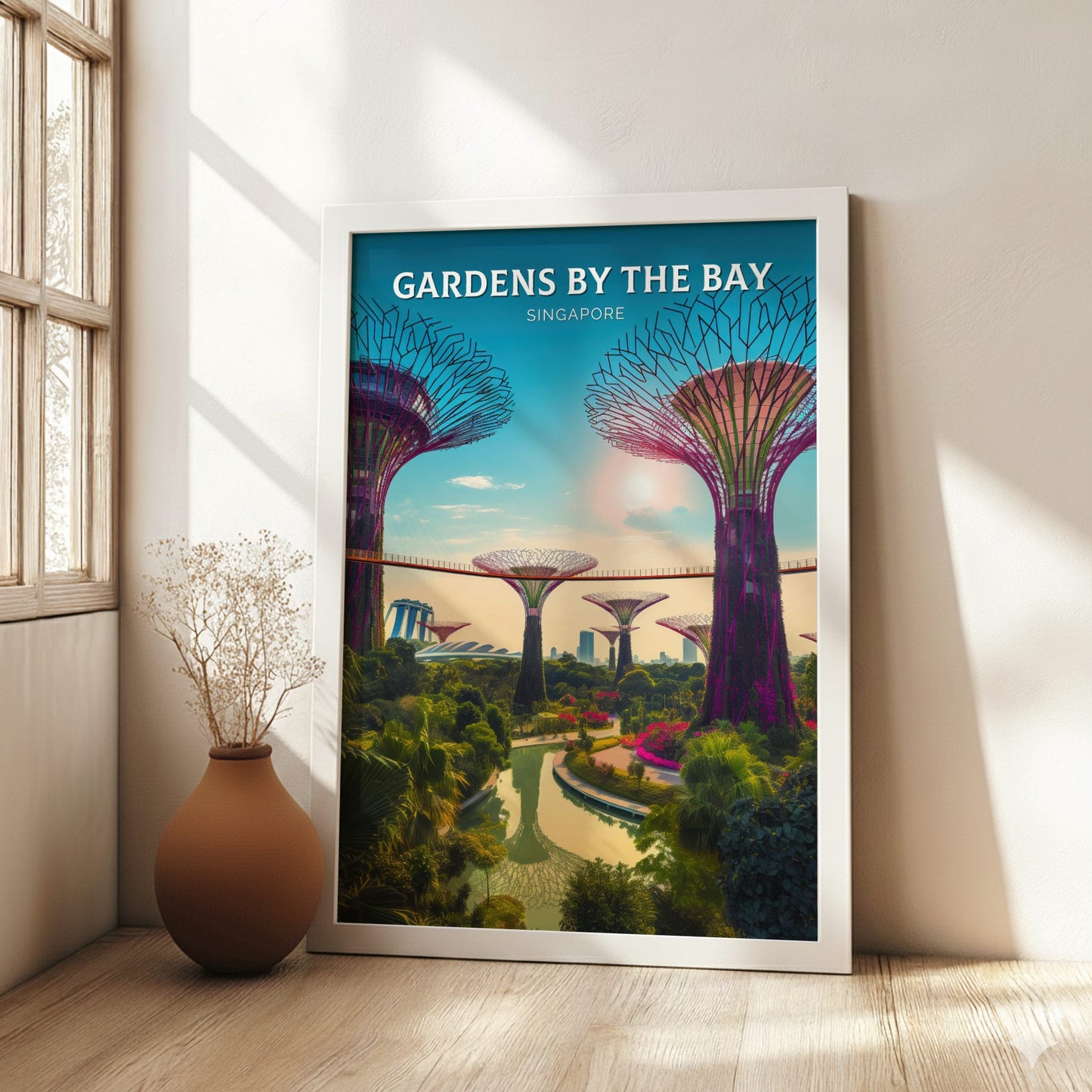 Framed poster of Gardens by the Bay in Singapore on a wall with a vase and plant below.