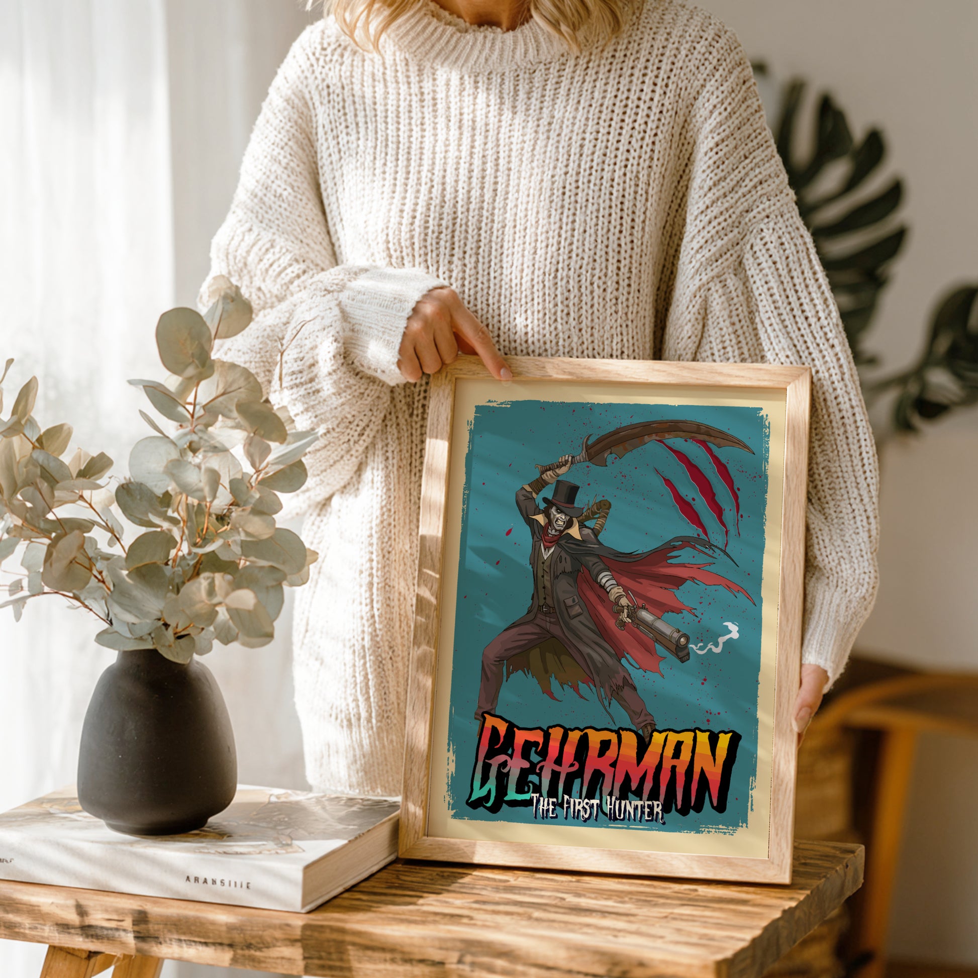 Person holding a framed artwork ofGehrman from Bloodborne  in a home setting.