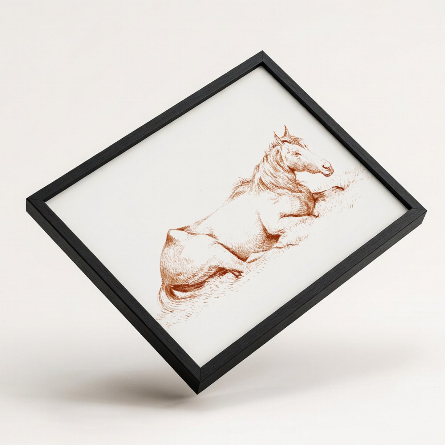 Vintage drawing of a horse lying in grass, rendered in brown ink, framed in wood.