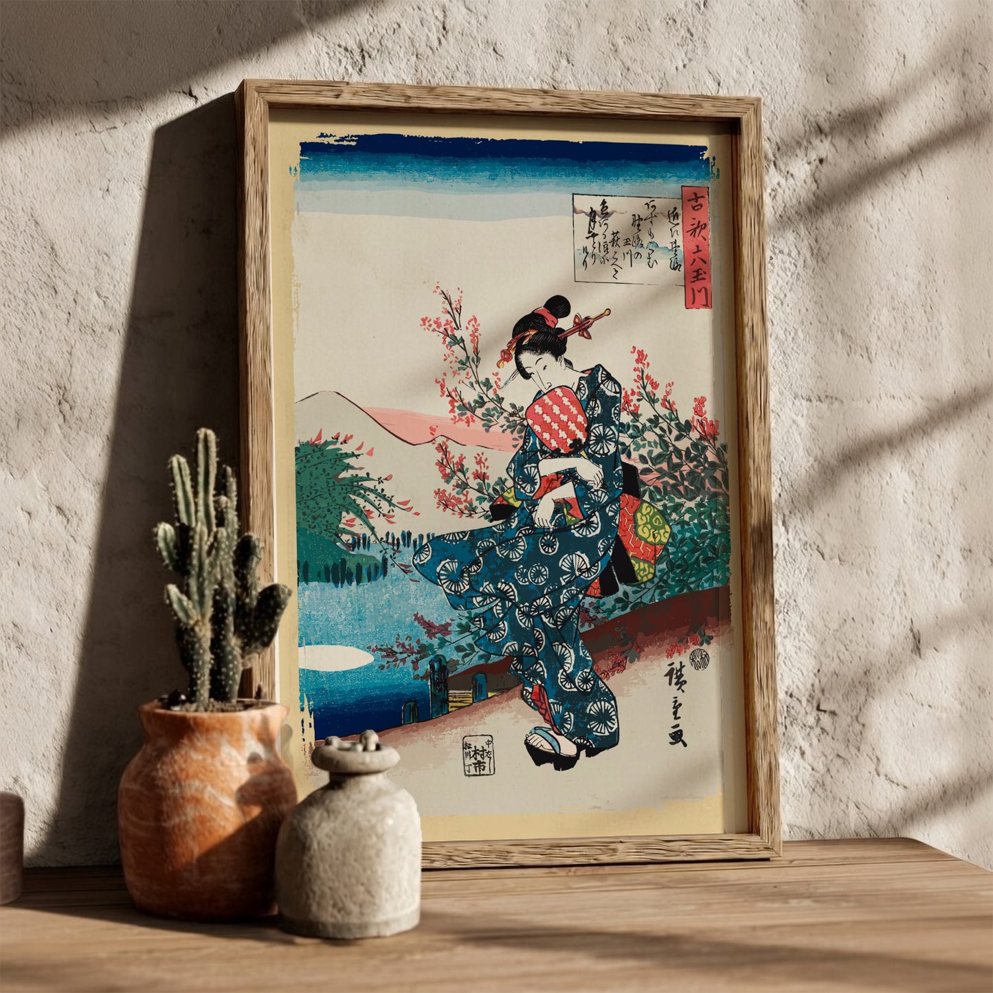 Vintage Japanese woodblock print poster of a woman in a blue kimono holding a fan, surrounded by cherry