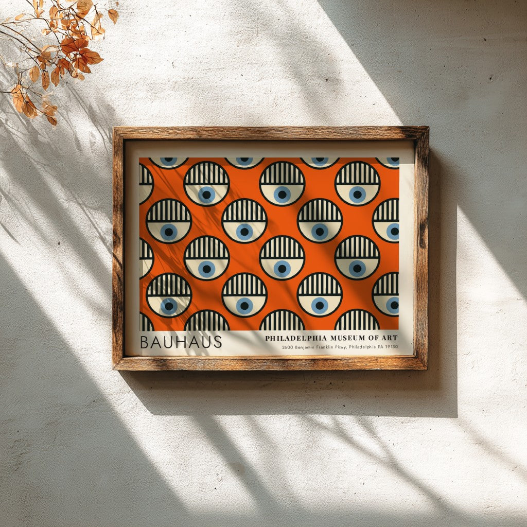 Bauhaus Philadelphia Museum of Art poster featuring repeating circular eye motifs on orange.