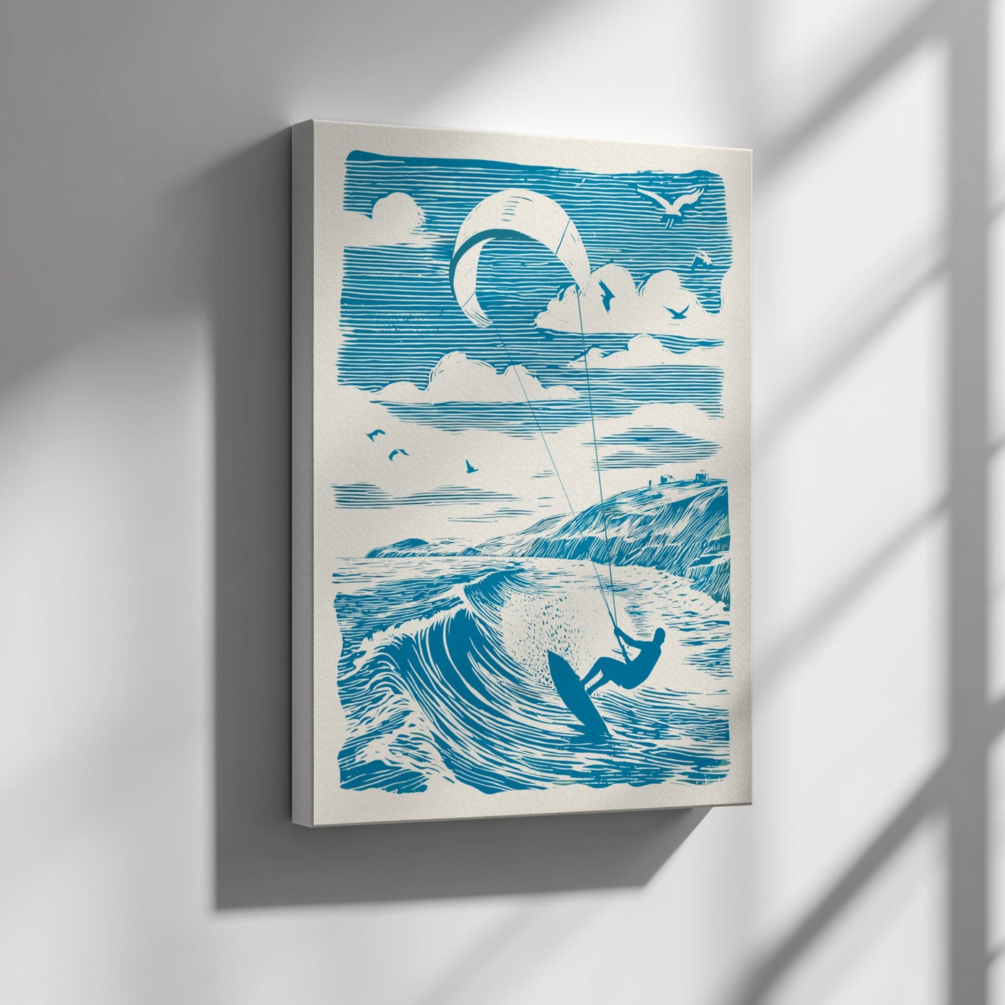 Framed artwork of a kitesurfer on a wave with a blue and white color scheme, hanging on a wall.