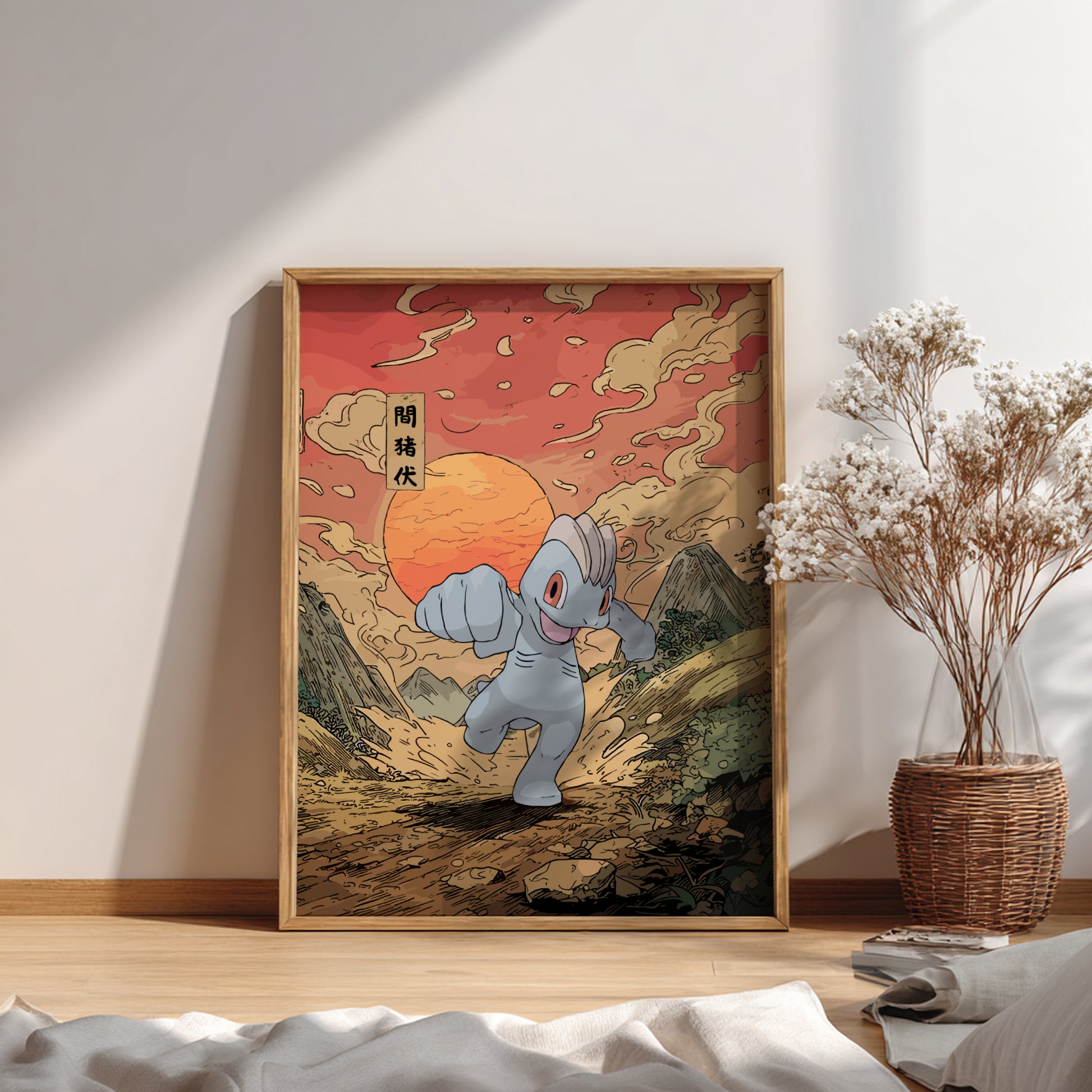 Framed artwork of Machop Pokemon in a mountainous landscape with a warm sunset, placed on a wooden floor.