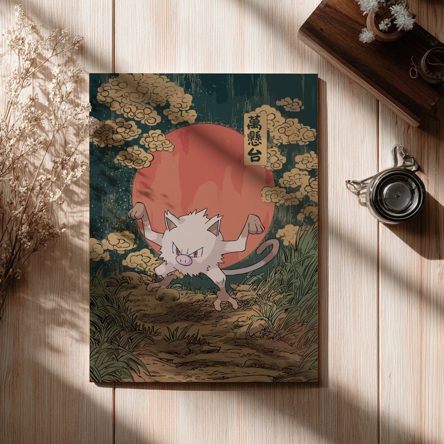 Poster with Mankey Pokemon illustration on a wooden surface with a cup and dried flowers.