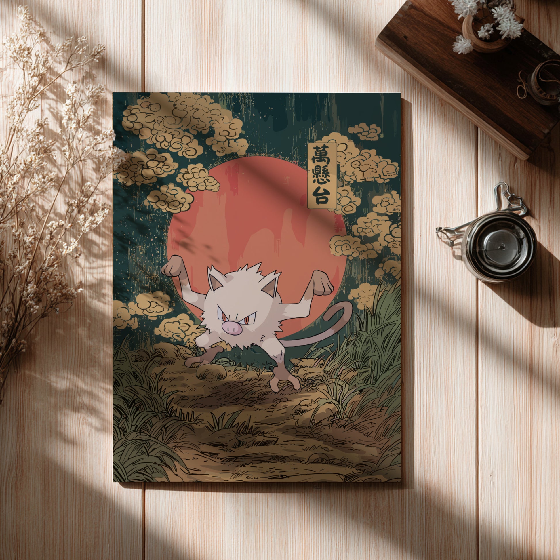 Poster with Mankey Pokemon illustration on a wooden surface with a cup and dried flowers.