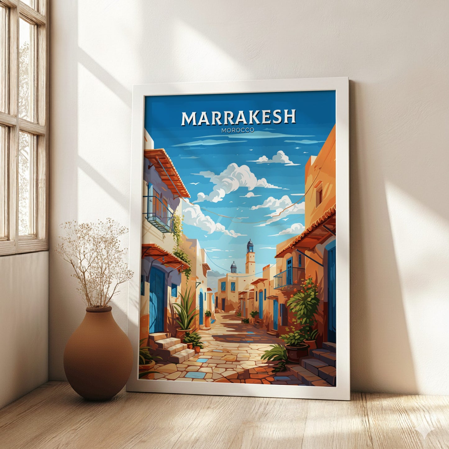 Framed artwork of Marrakesh, Morocco with a street scene and blue sky.