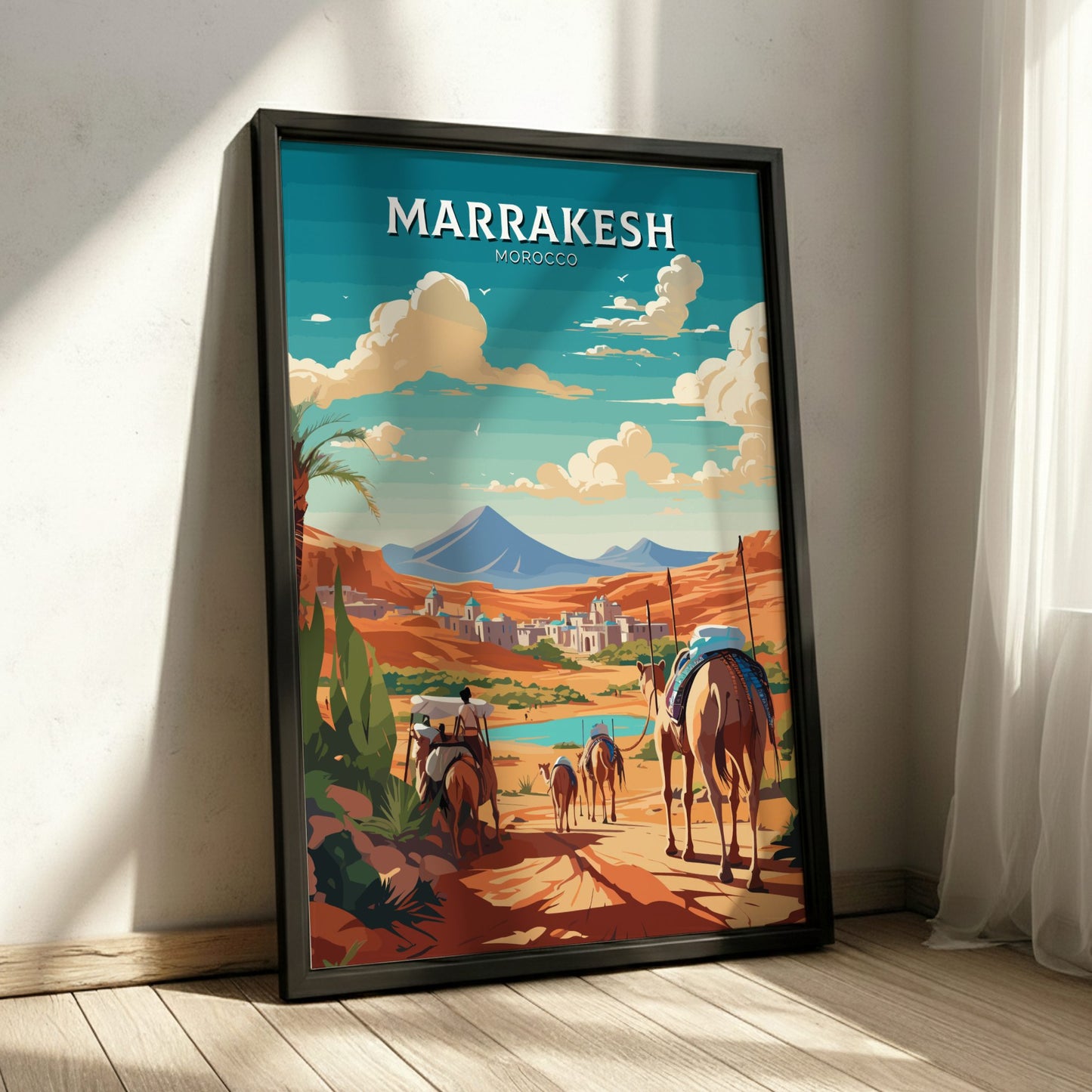 Framed poster of Marrakesh with camels and mountains on a wall.
