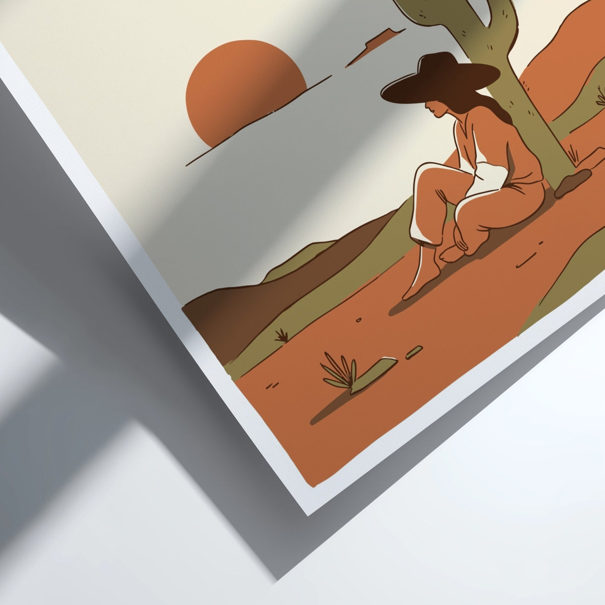 Poster of a woman sitting under a saguaro cactus during a desert sunset