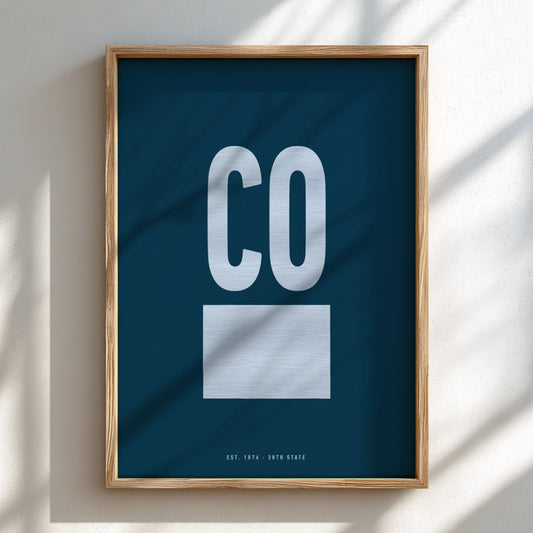 Framed poster with 'CO' on a blue background