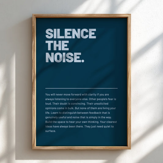 Framed poster with motivational quote 'Silence the Noise' on a blue background