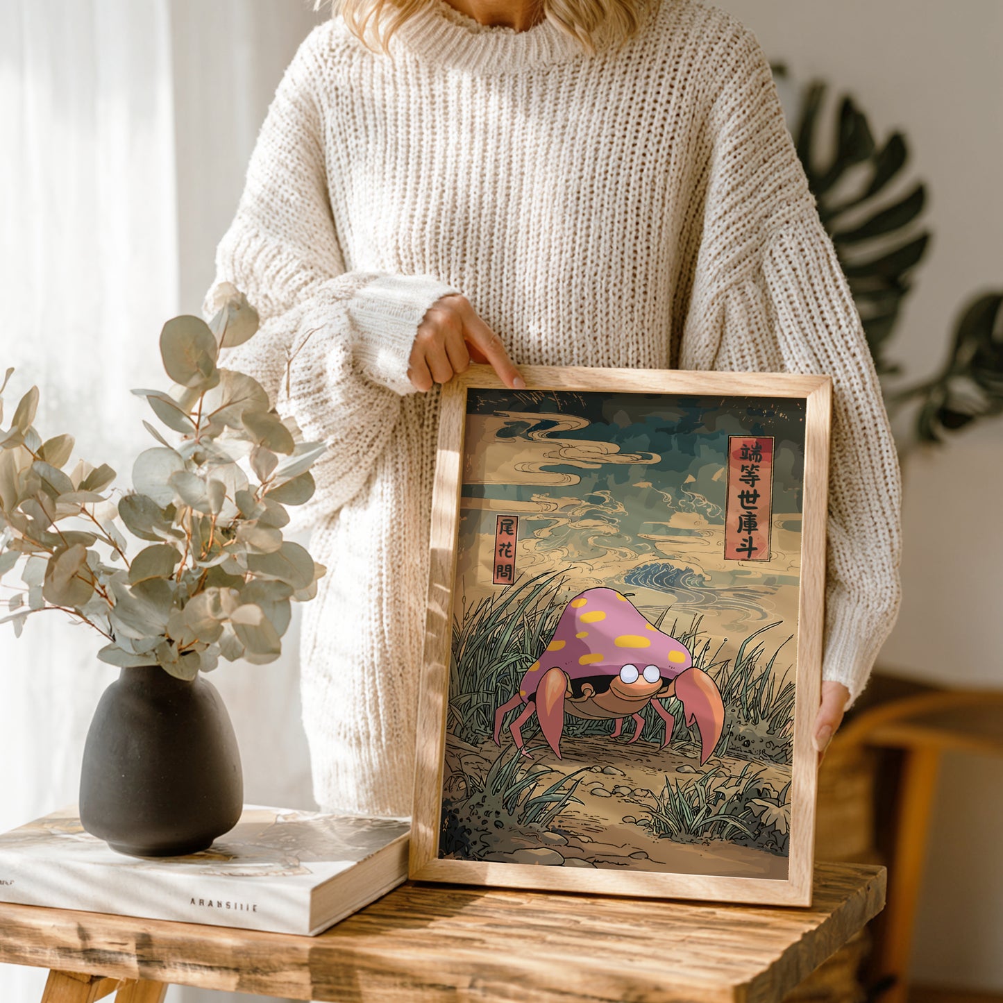 Person holding a framed illustration of Parasect Pokemon in a natural setting