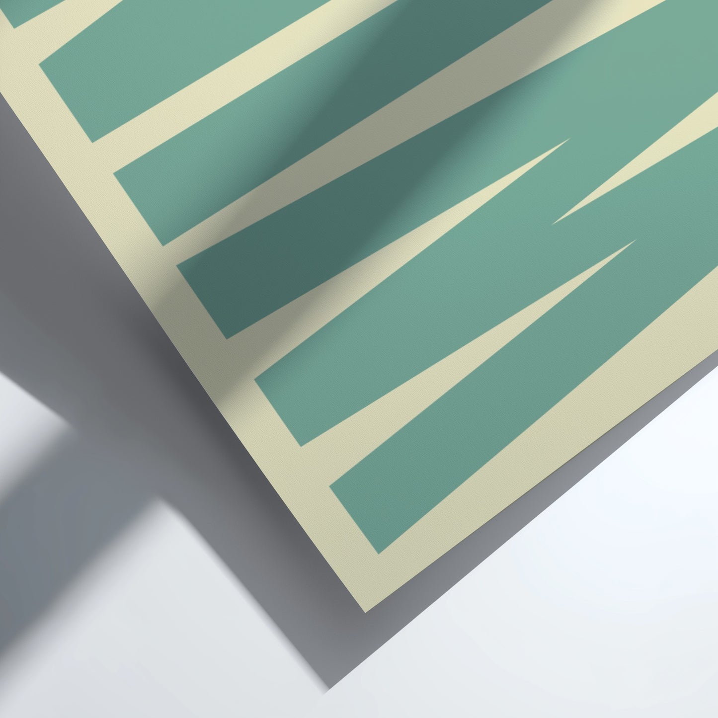 Teal and beige patterned paper on a white background