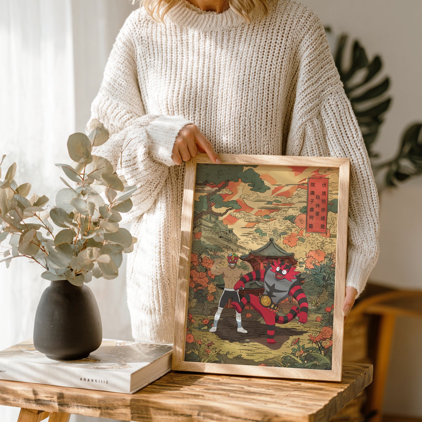 Person holding a framed artwork of Professor Kukui and Incineroar Pokemon with a wooden frame.