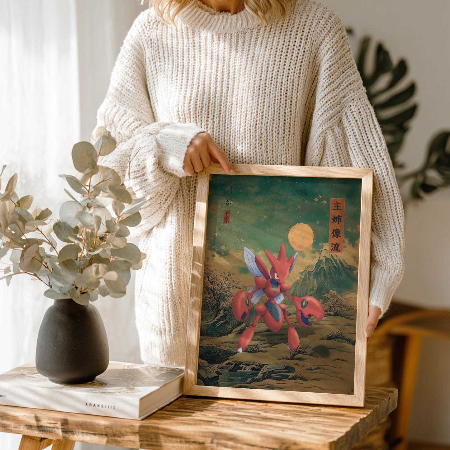 Person holding a framed artwork of Scizor Pokemon in a natural setting
