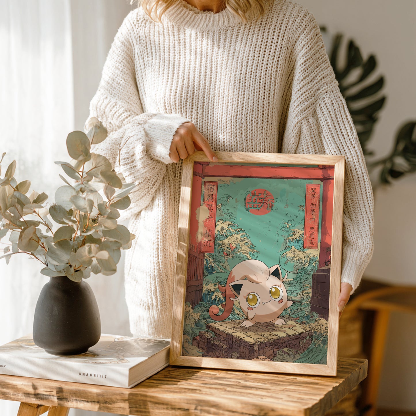 Person holding a framed artwork of aScream Tail Pokemon with a decorative background