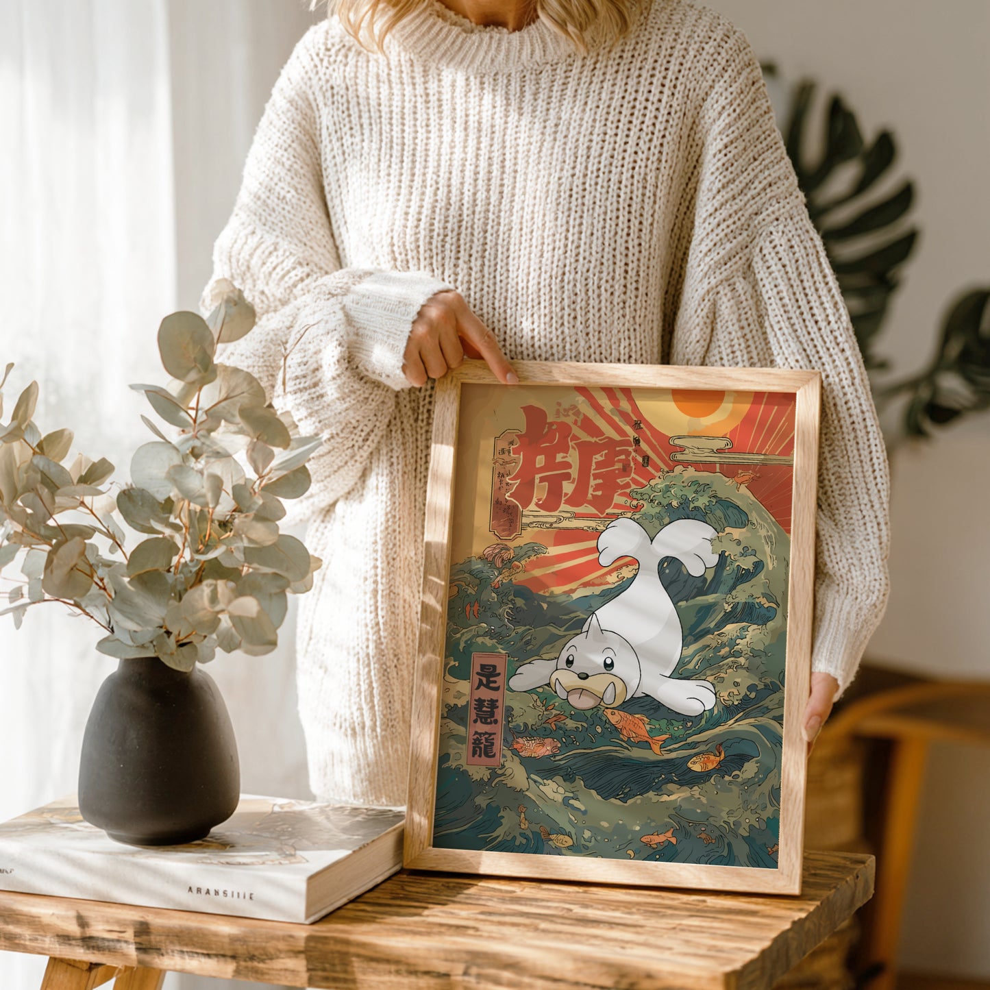 Person holding a framed artwork of Seel Pokemon in a natural setting