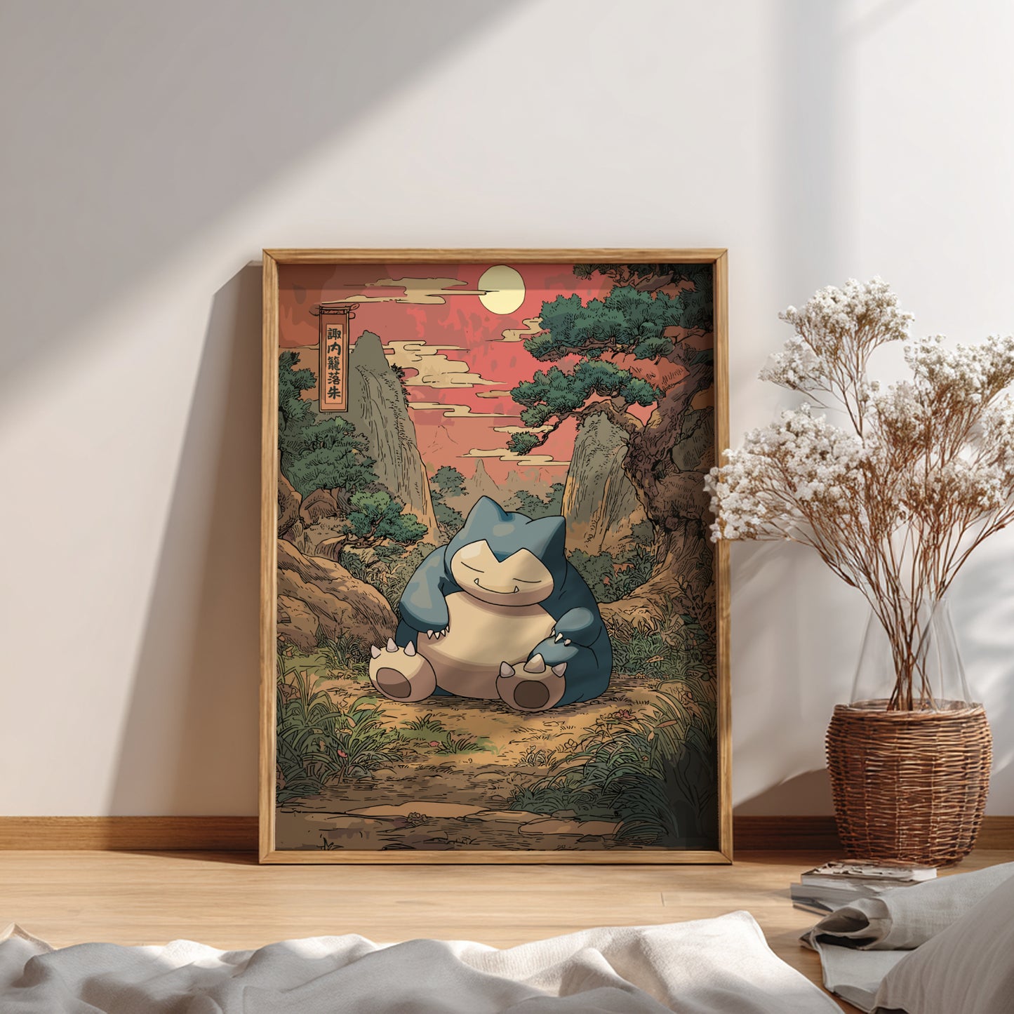 Framed artwork of Snorlax Pokemon character in a natural setting on a wall.