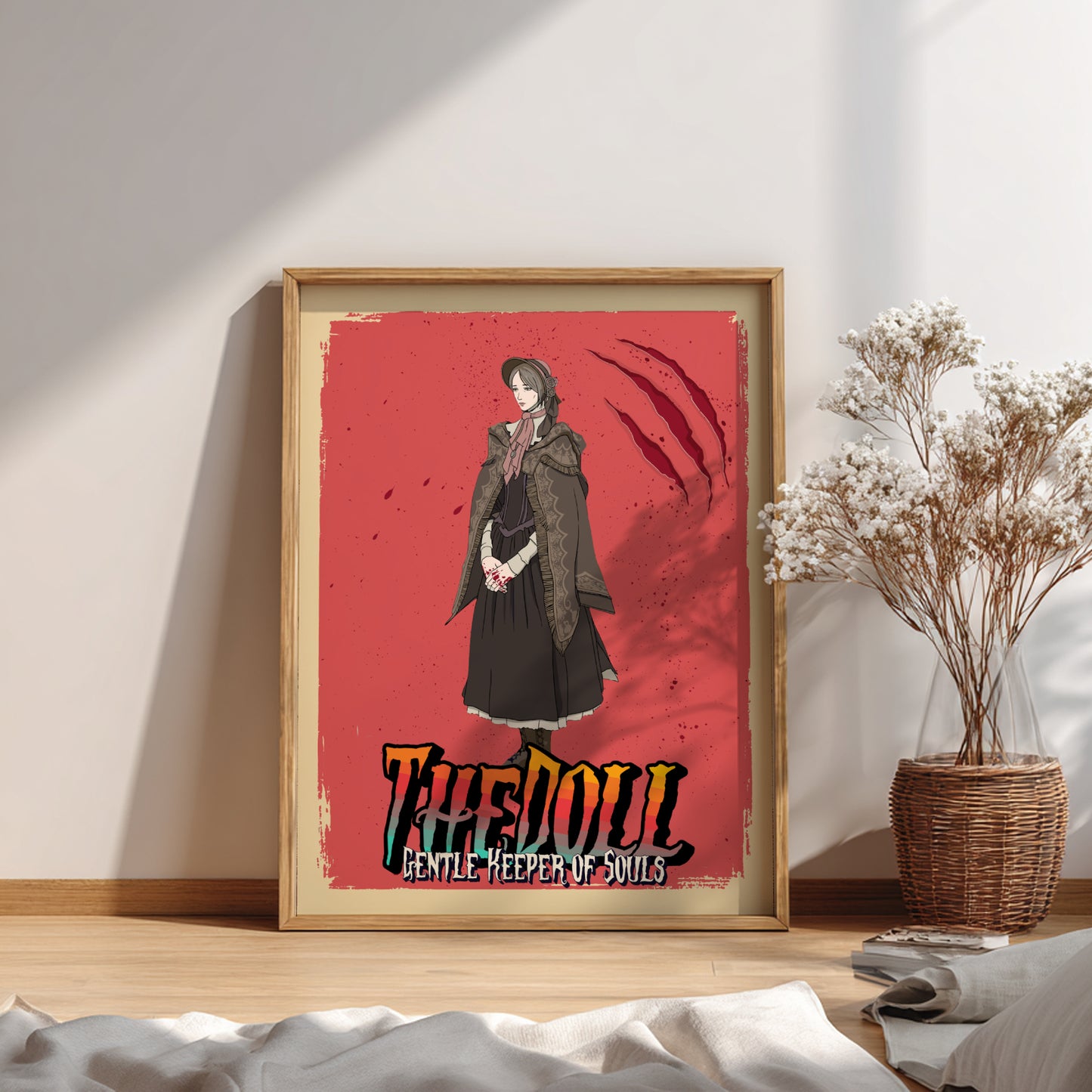 Framed artwork of The Doll from Bloodborne on a red background, placed on a wooden surface.