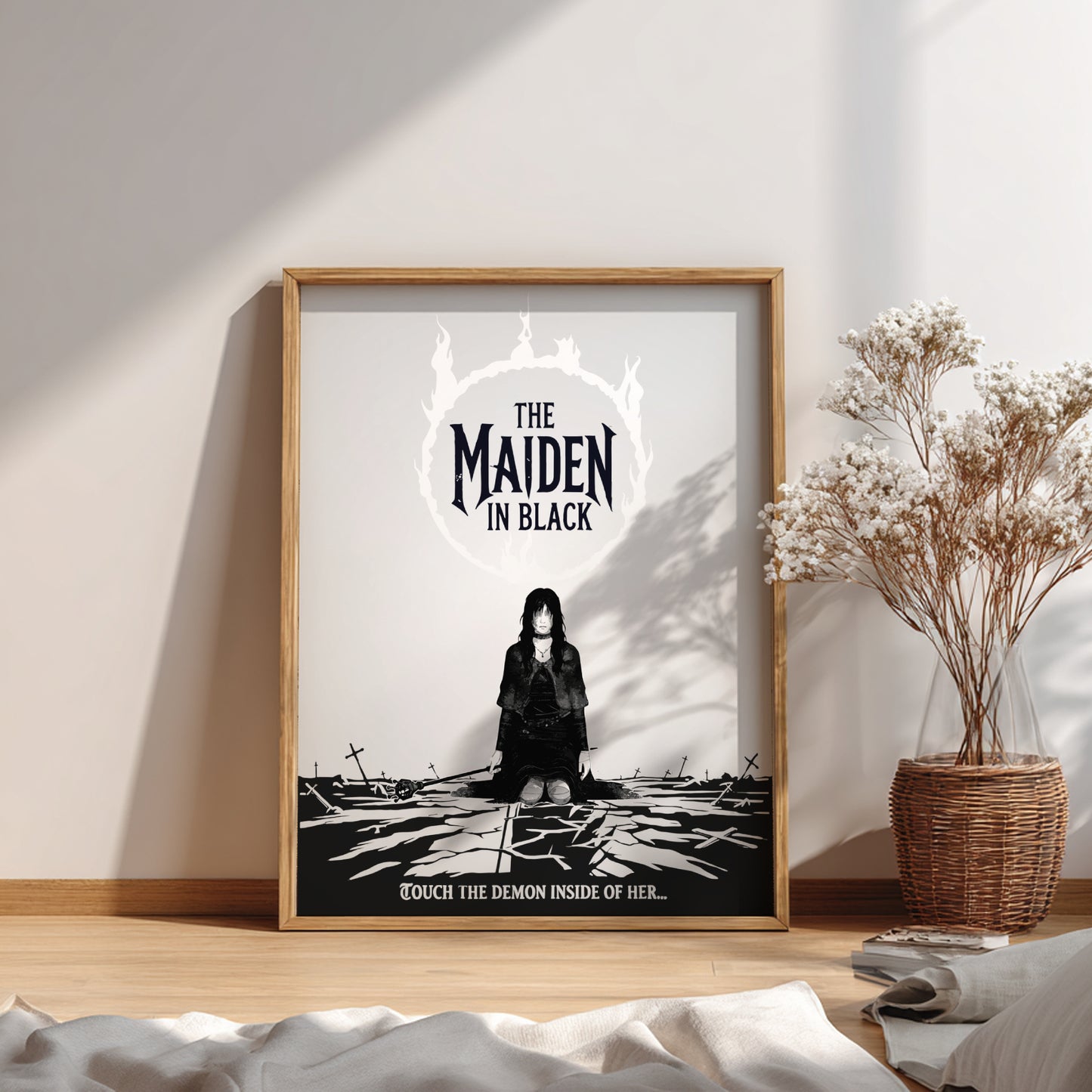 Framed poster of The Maiden in Black from Dark Souls on a wall with a plant and decor.