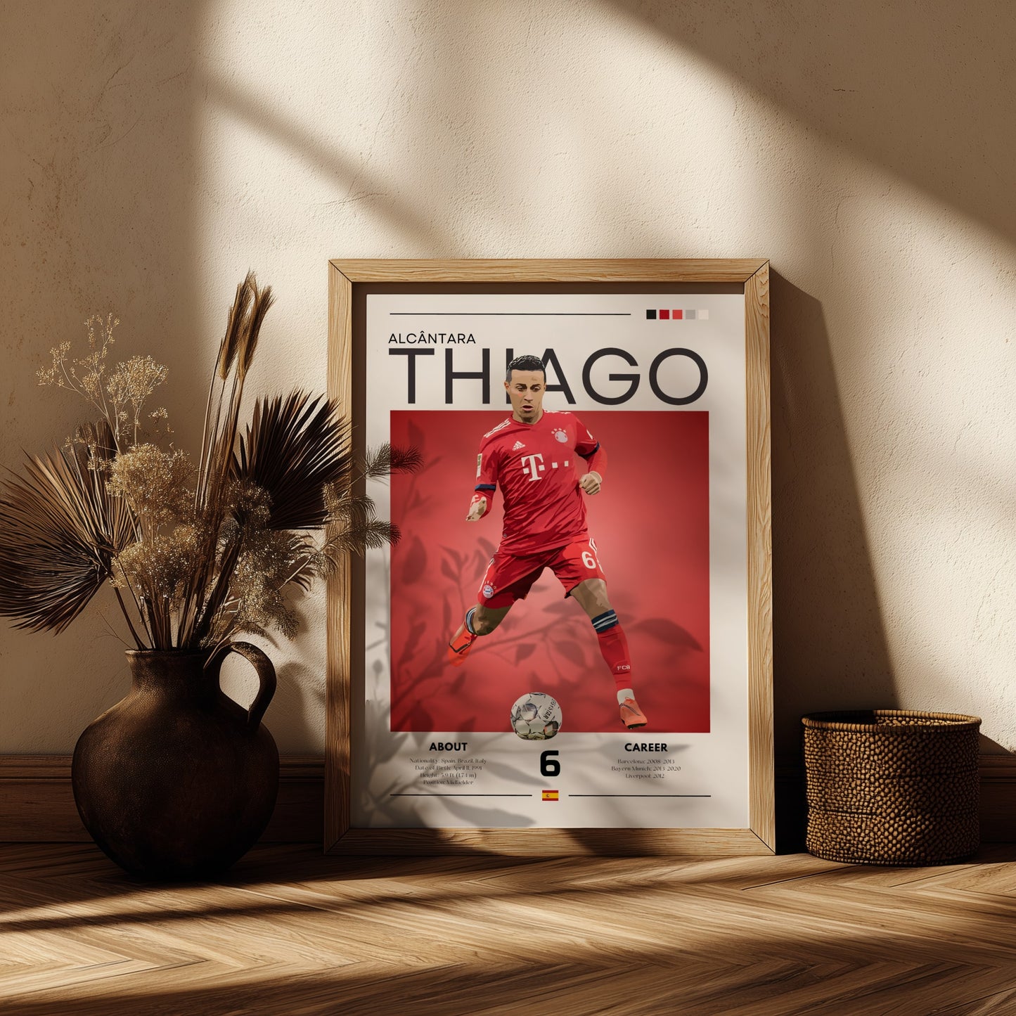Framed poster of a soccer player in a red jersey on a wooden shelf with decorative plants.