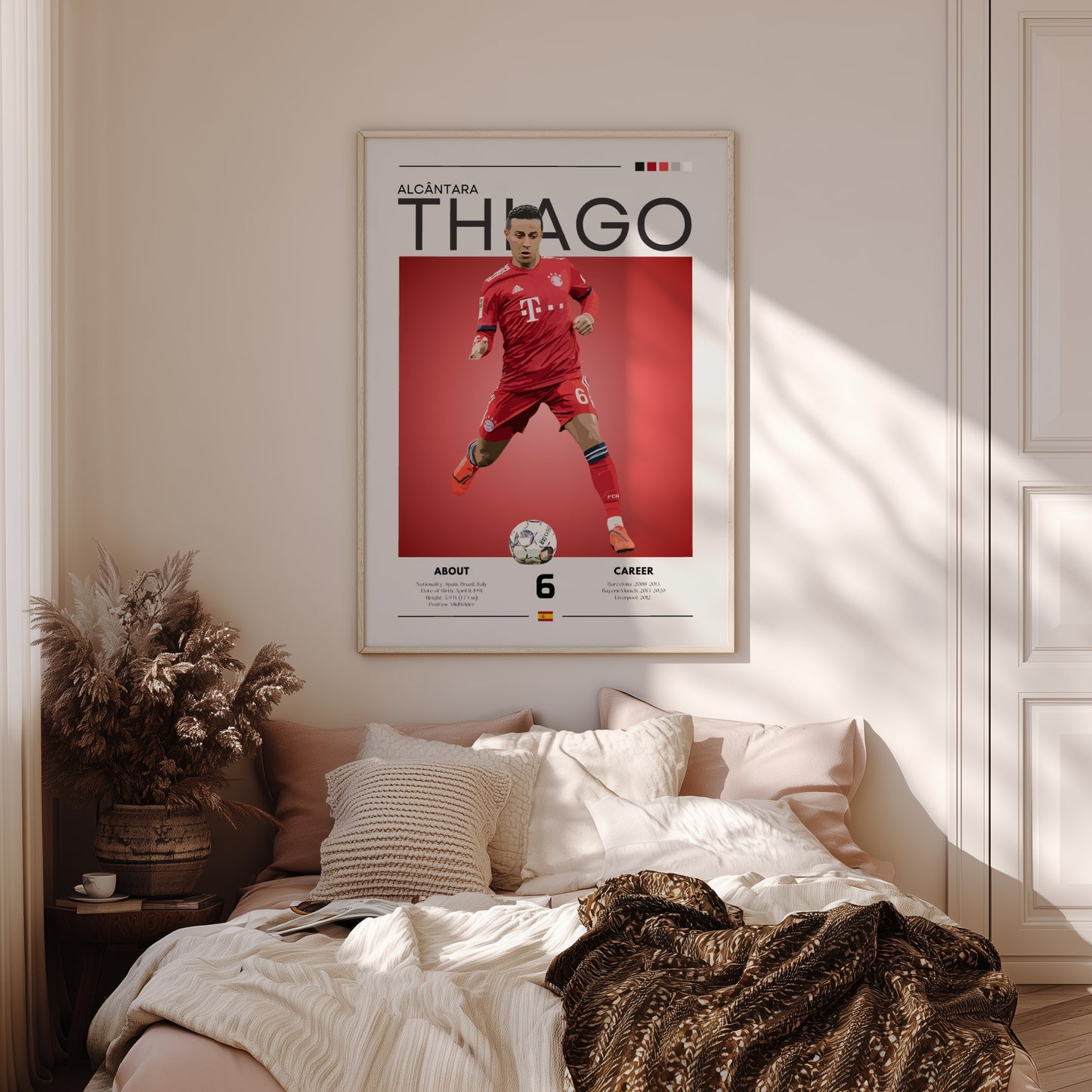 Framed poster of a soccer player on a wall above a bed in a bedroom.