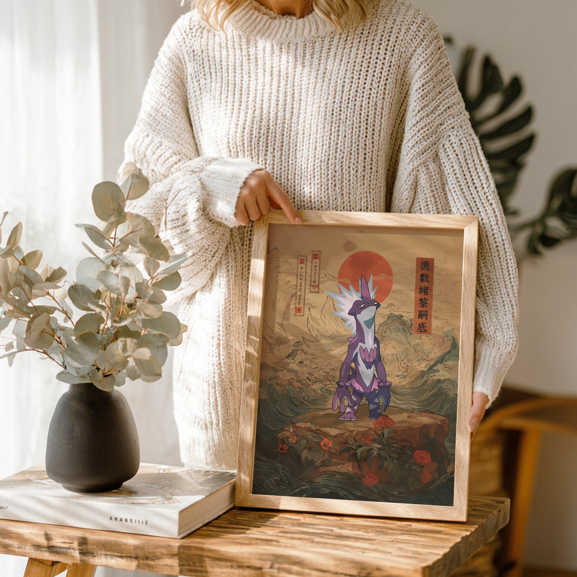 Person holding a framed artwork of a stylized Toxtricity Pokemon in a natural setting