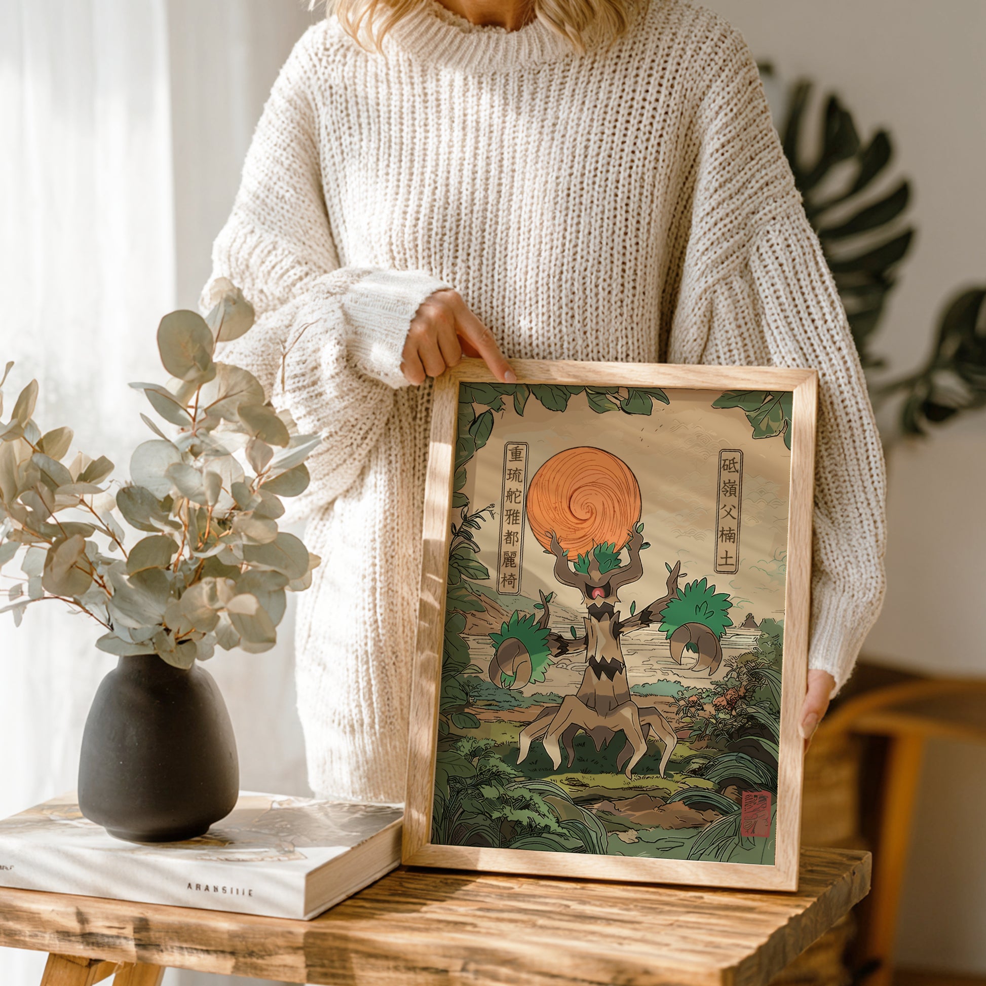 Person holding a framed artwork with a nature-themed design of Trevenant Pokemon, standing in a room with plants and decor.