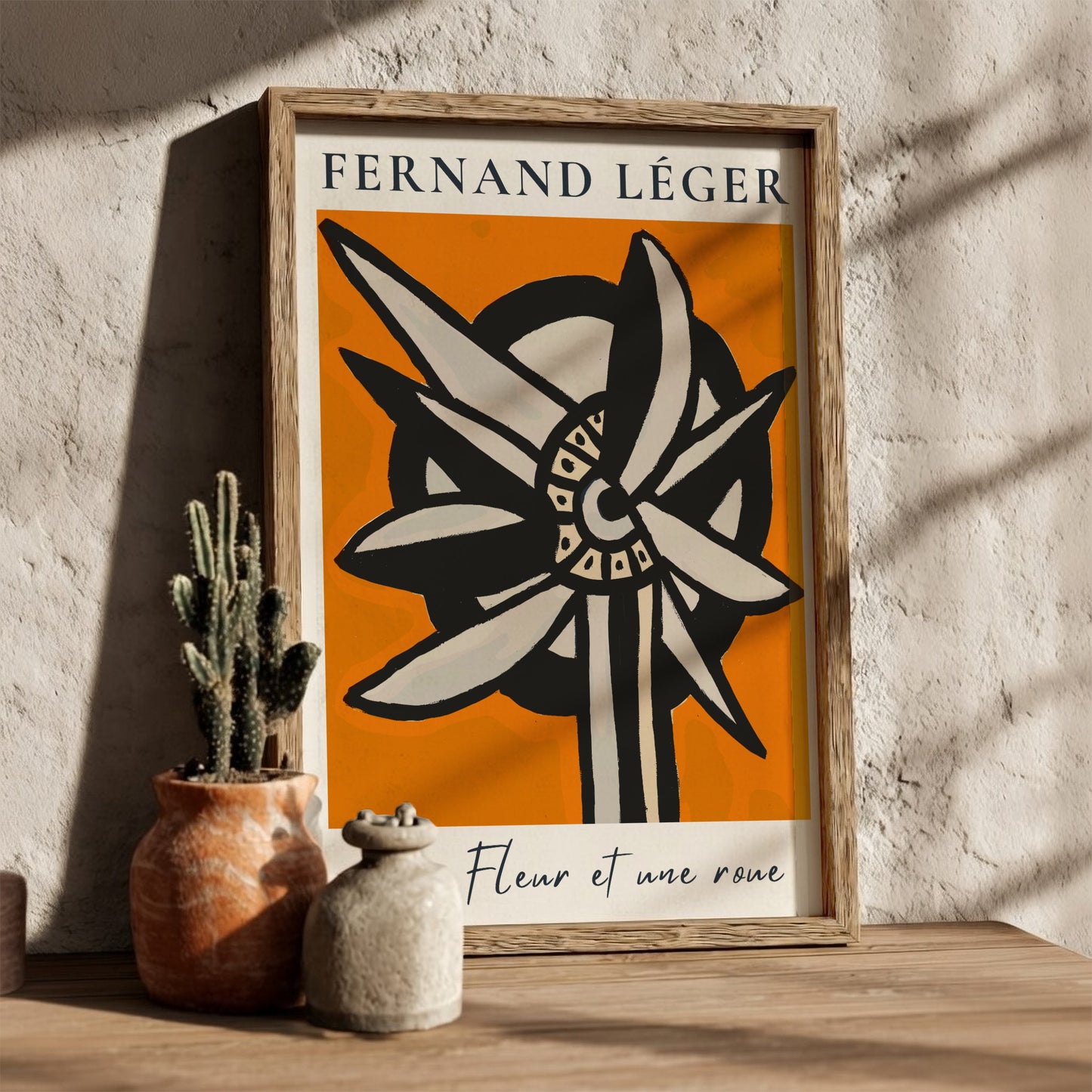 Fernand Léger "Une Fleur et une roue" poster with abstract flower/wheel design on orange background.