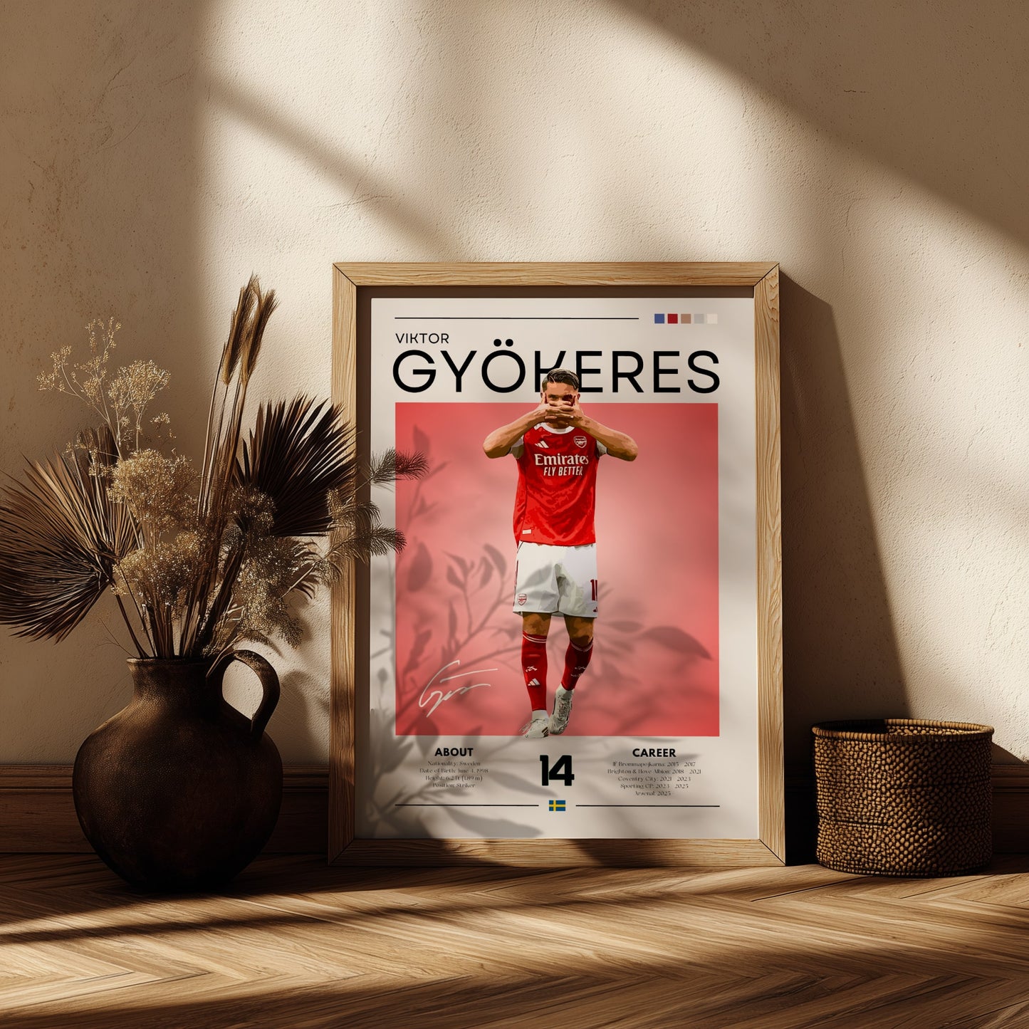 Framed poster of a soccer player in a red jersey on a wooden shelf with decorative plants.