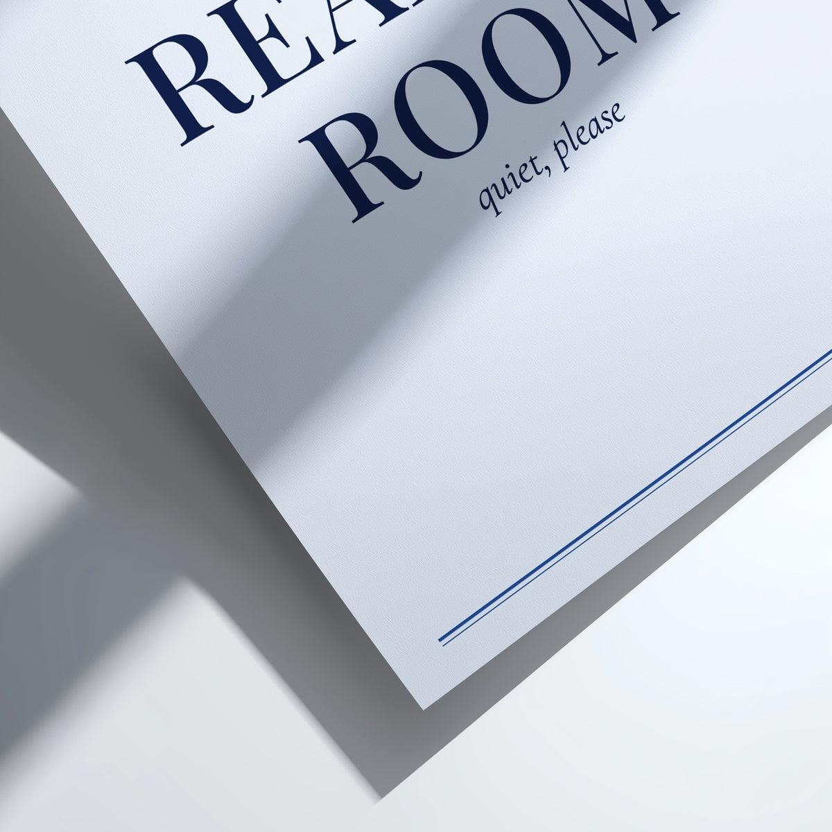 A close-up of a white paper sign or poster with navy blue text reading 'ROOM quiet, please' and partial text 'REA.