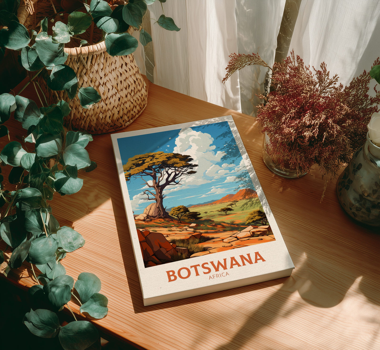 Book titled 'Botswana' on a wooden table with plants around