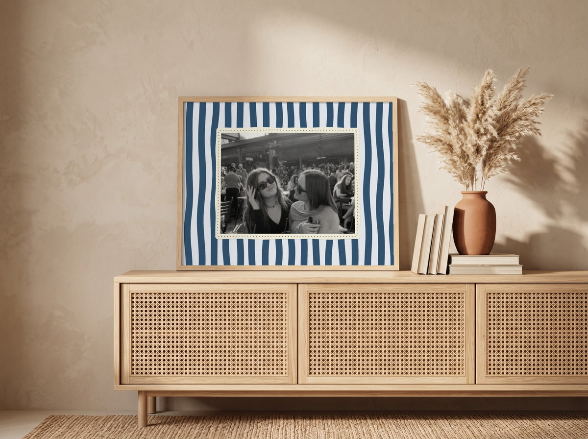 Personalised Wavy Stripes Landscape Photo Poster in an oak frame leaning against a wall in a boho room