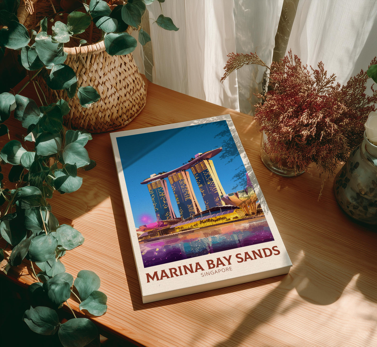 Canvas with Marina Bay Sands cover on a wooden table with plants