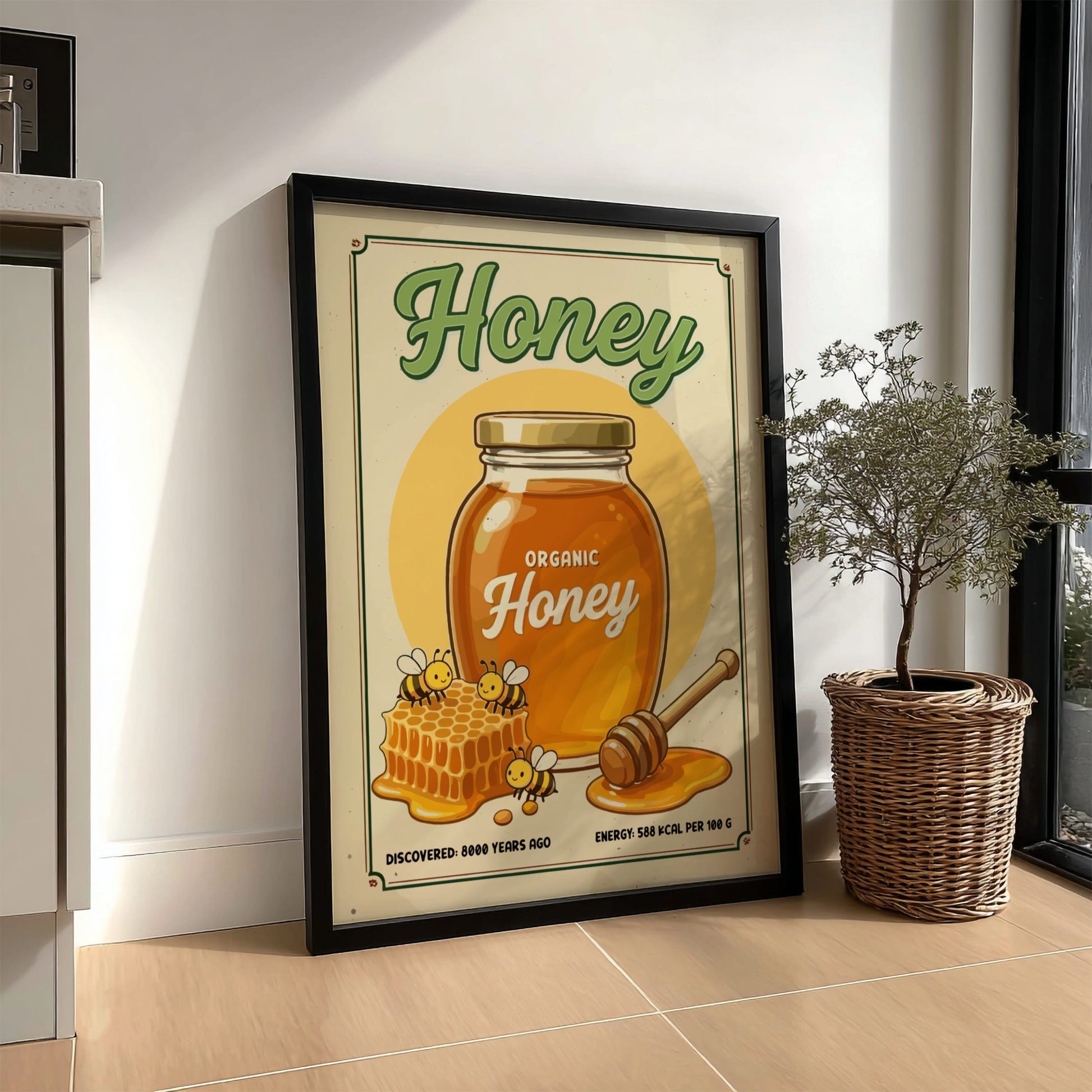 Framed poster of a honey jar with bees and honeycomb on a wall.