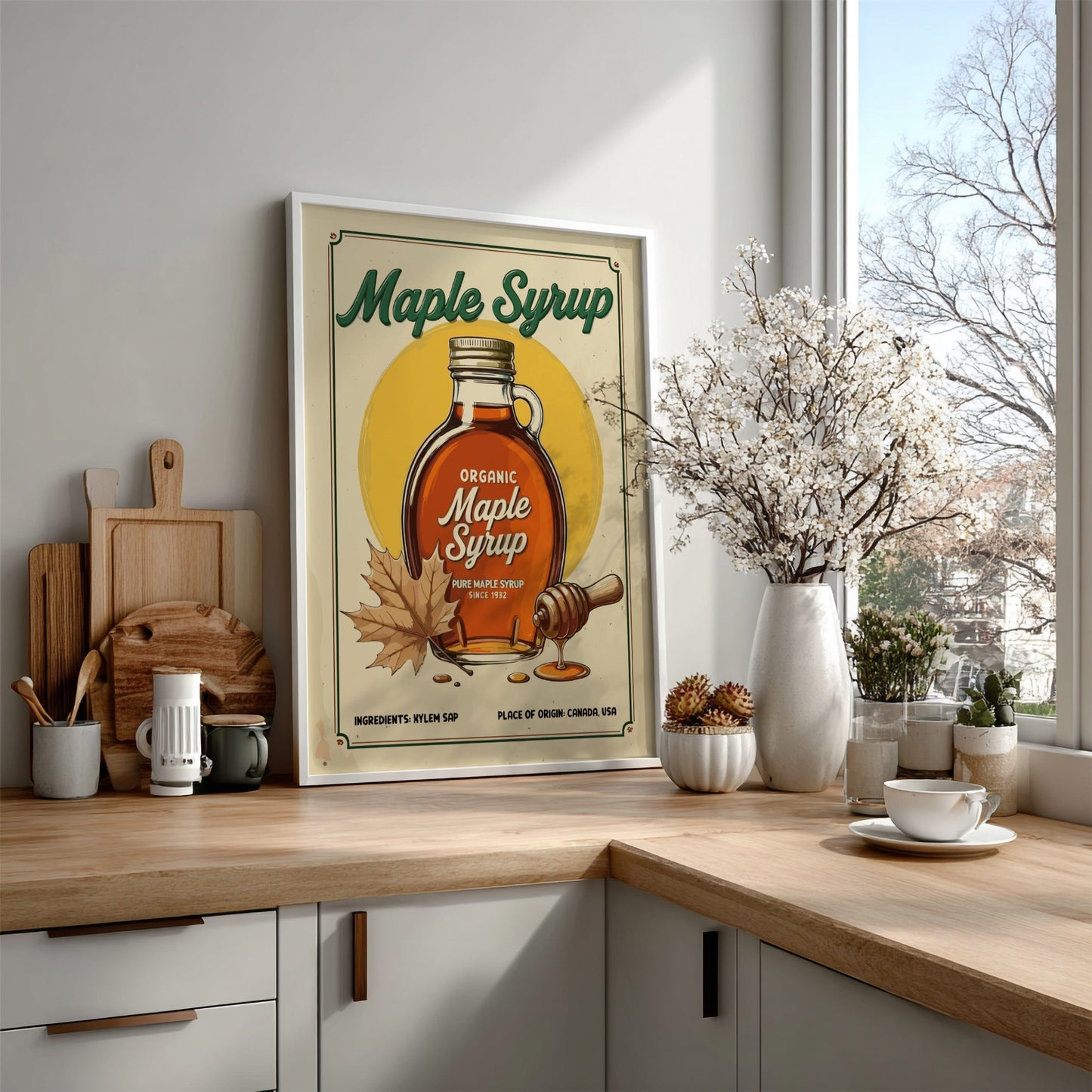 Kitchen counter with a framed maple syrup poster, wooden cutting boards, and decorative items.