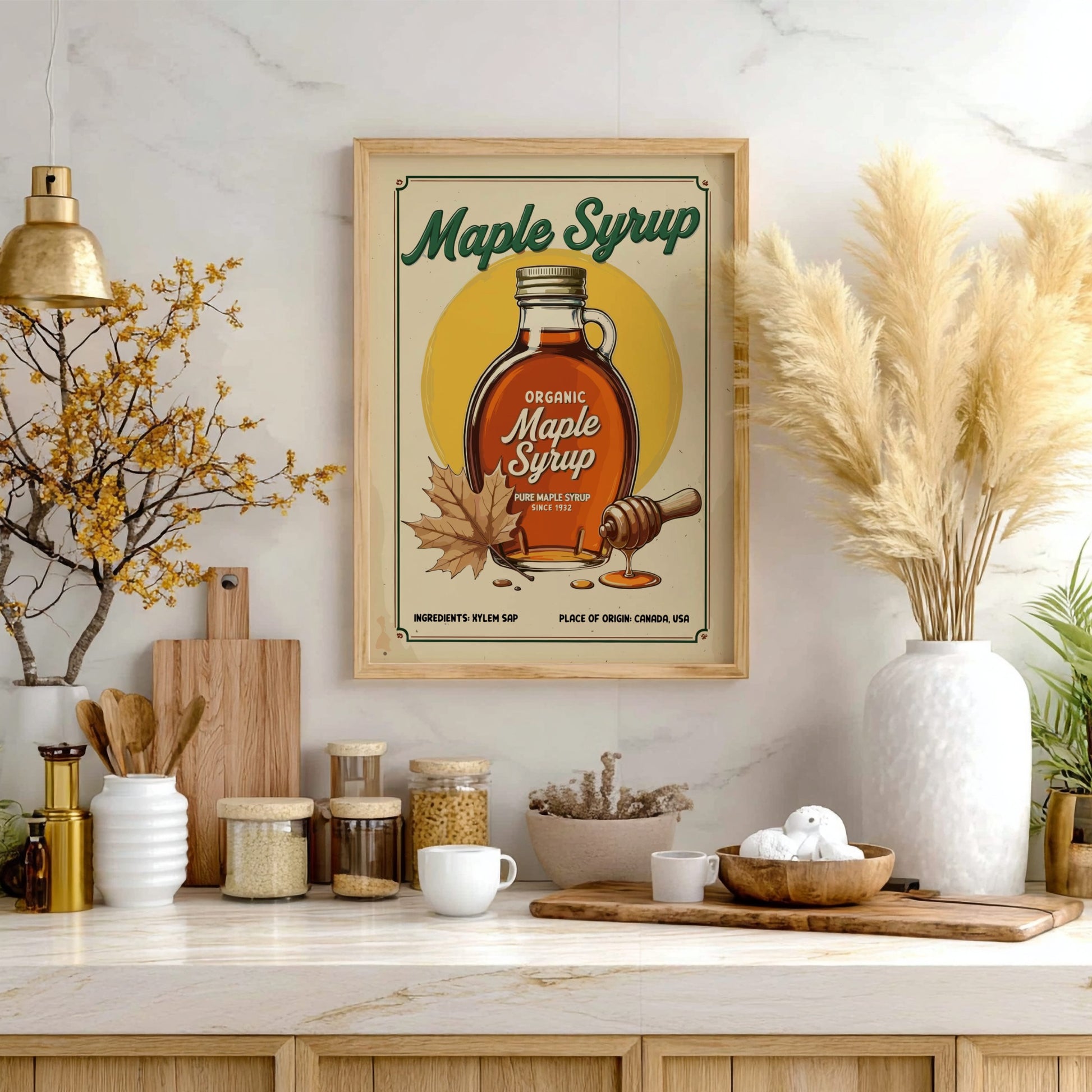 Framed maple syrup poster on a kitchen wall with various kitchen items below.