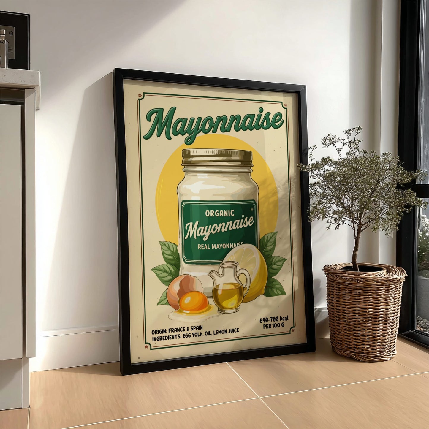 Framed vintage-style mayonnaise advertisement on a wall next to a plant