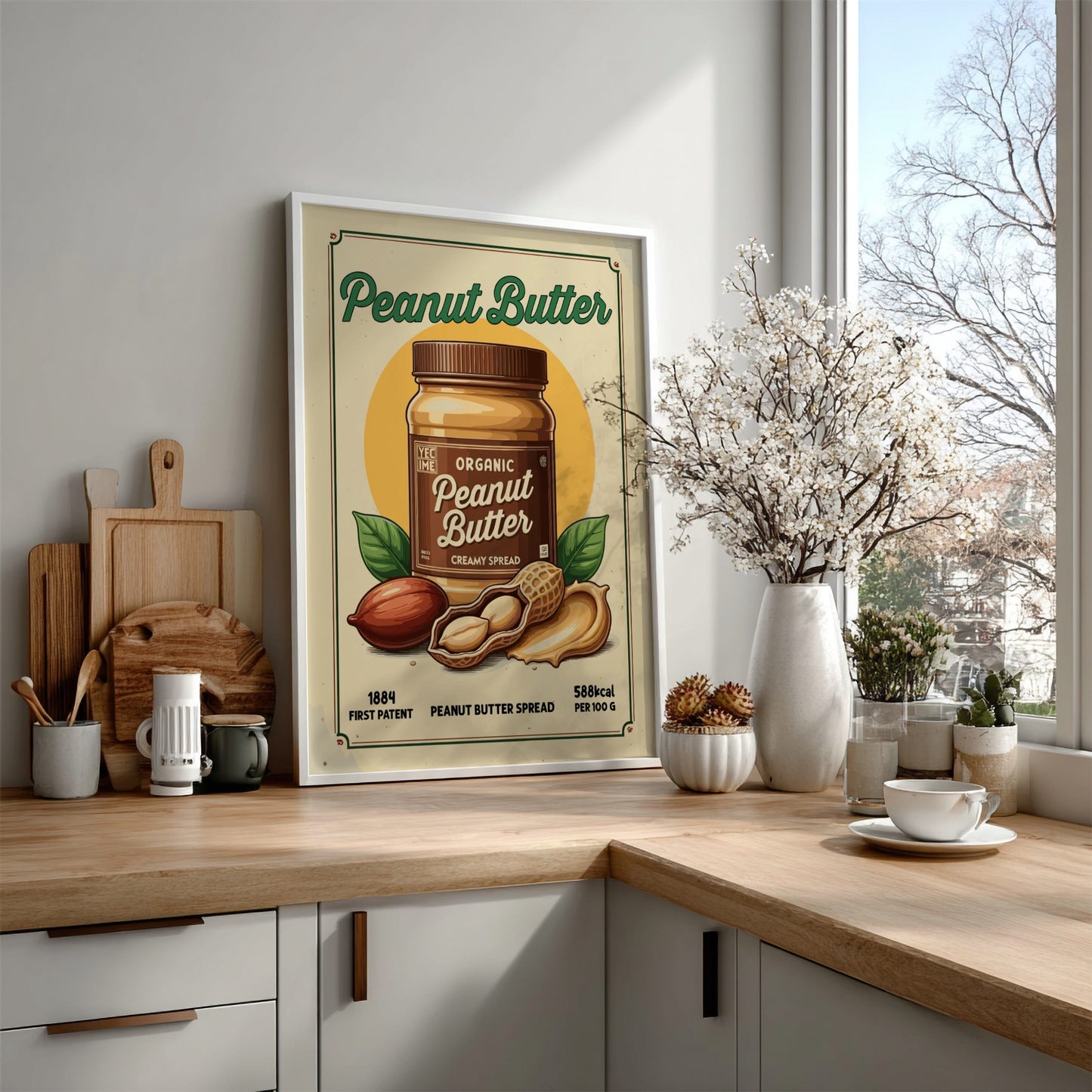 Kitchen counter with a peanut butter-themed poster, wooden cutting boards, and decorative items.