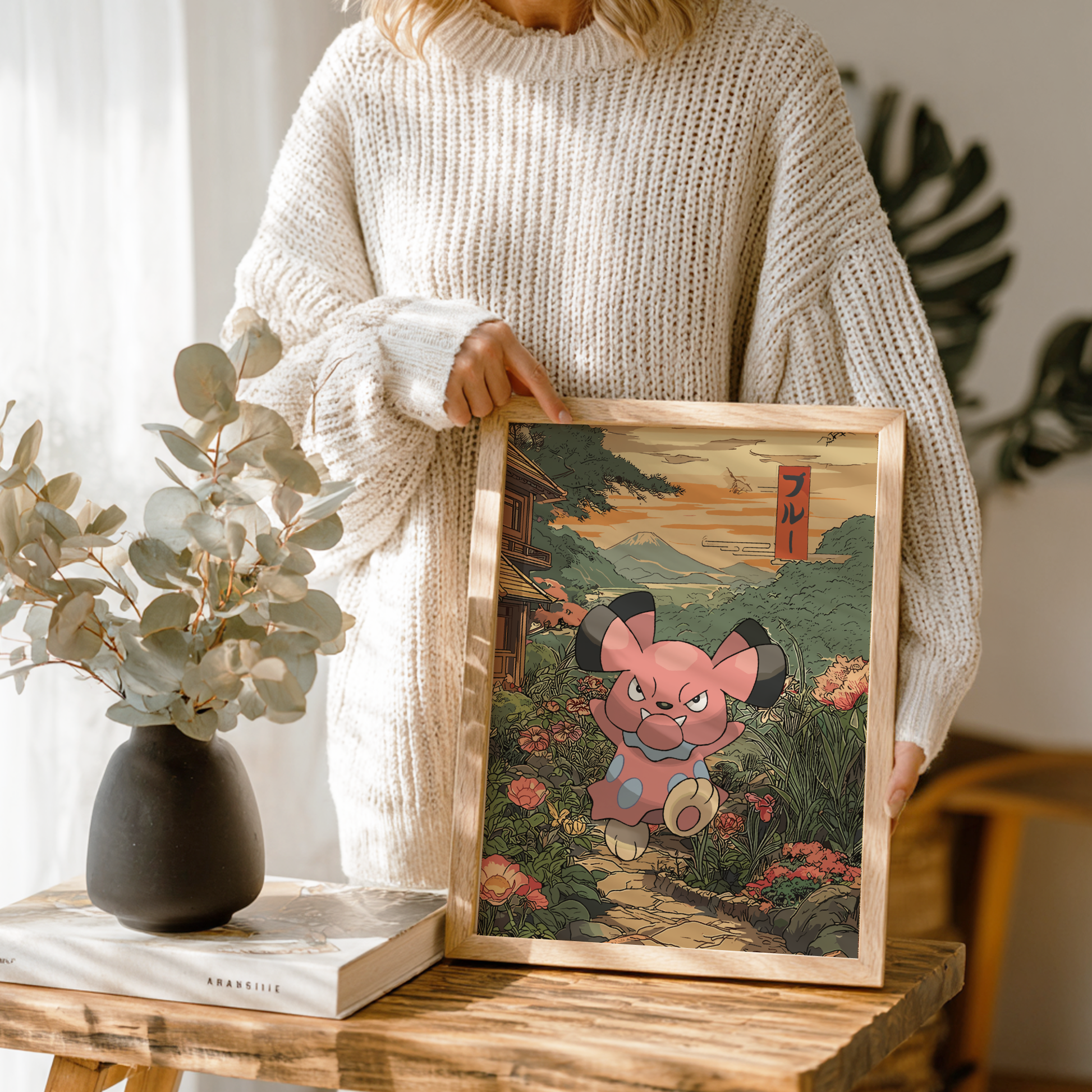 Person holding a framed artwork of Snubbull Pokémon in a natural setting